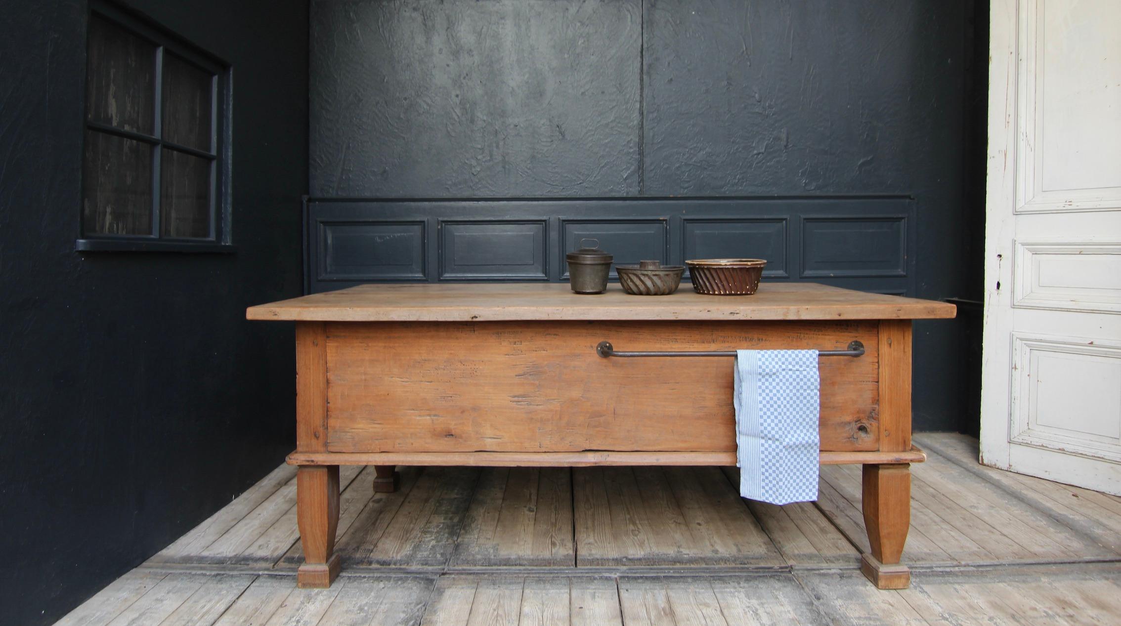 Kitchen preparation table from the early 19th century. Modified for use as a kitchen island.

Solid rectangular oak corpus standing on 4 tapered square legs with very high frame and projecting table top.

The furniture has been exclusively
