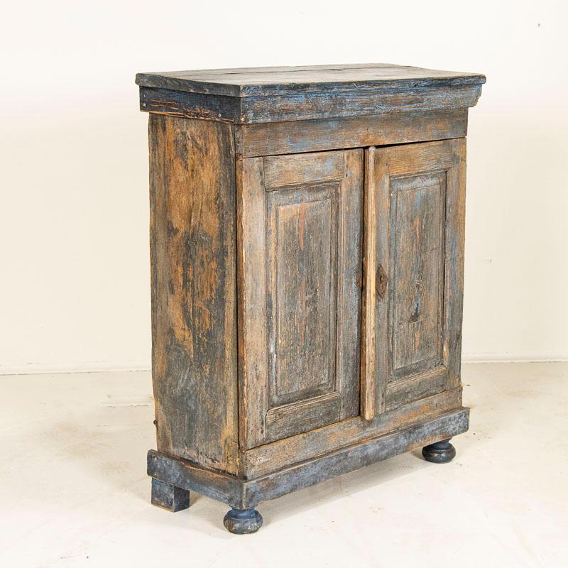 While you can frequently still find antique pine cabinets, it is harder to find a sideboard with original blue/gray paint such as this one. This cabinet is a charming representation of rustic Swedish country craftsmanship, gently distressed over