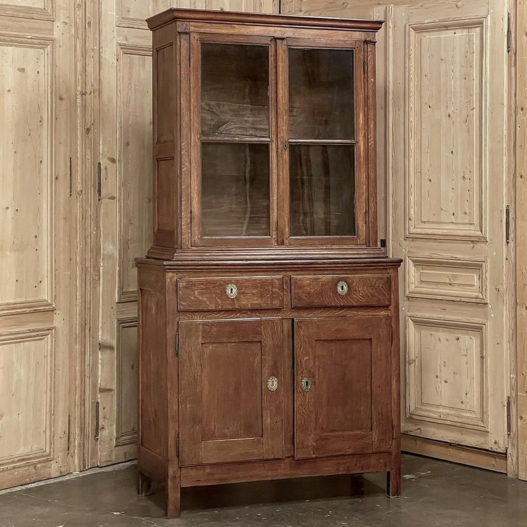 Early 19th century rustic two-tiered bookcase ~ display case was crafted by talented rural artisans who followed the lead of the court's style dictates of the era. This piece falls during the transition from the Directoire style to the Louis
