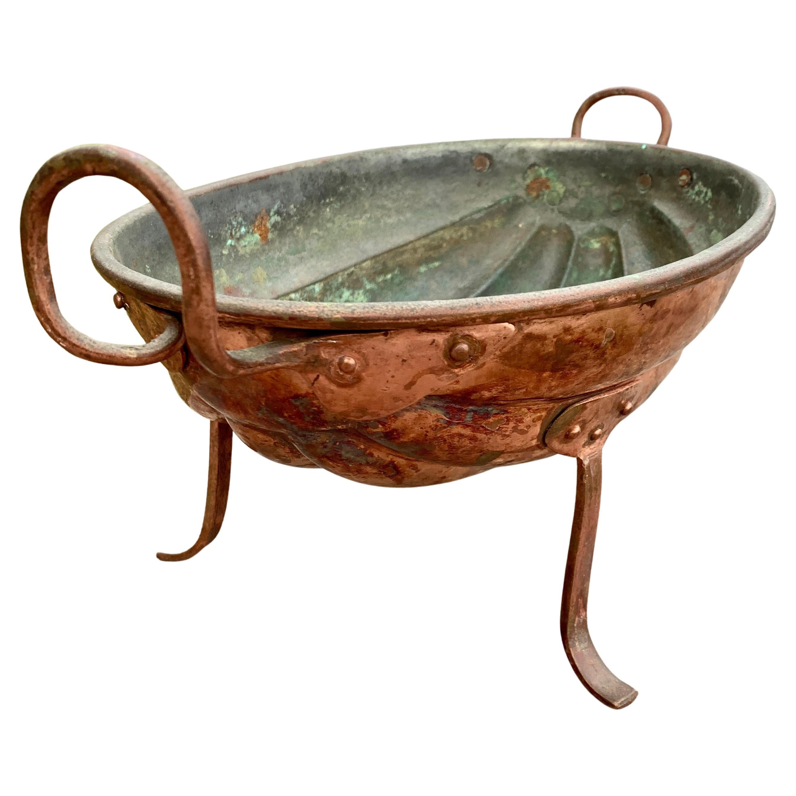 An early 19th century Danish hand hammered copper mold for wall decoration in a kitchen or a dining room. It can also be used as a bowl standing stable on its legs. 
The mold has only been lightly polished in order to keep the original old patina.