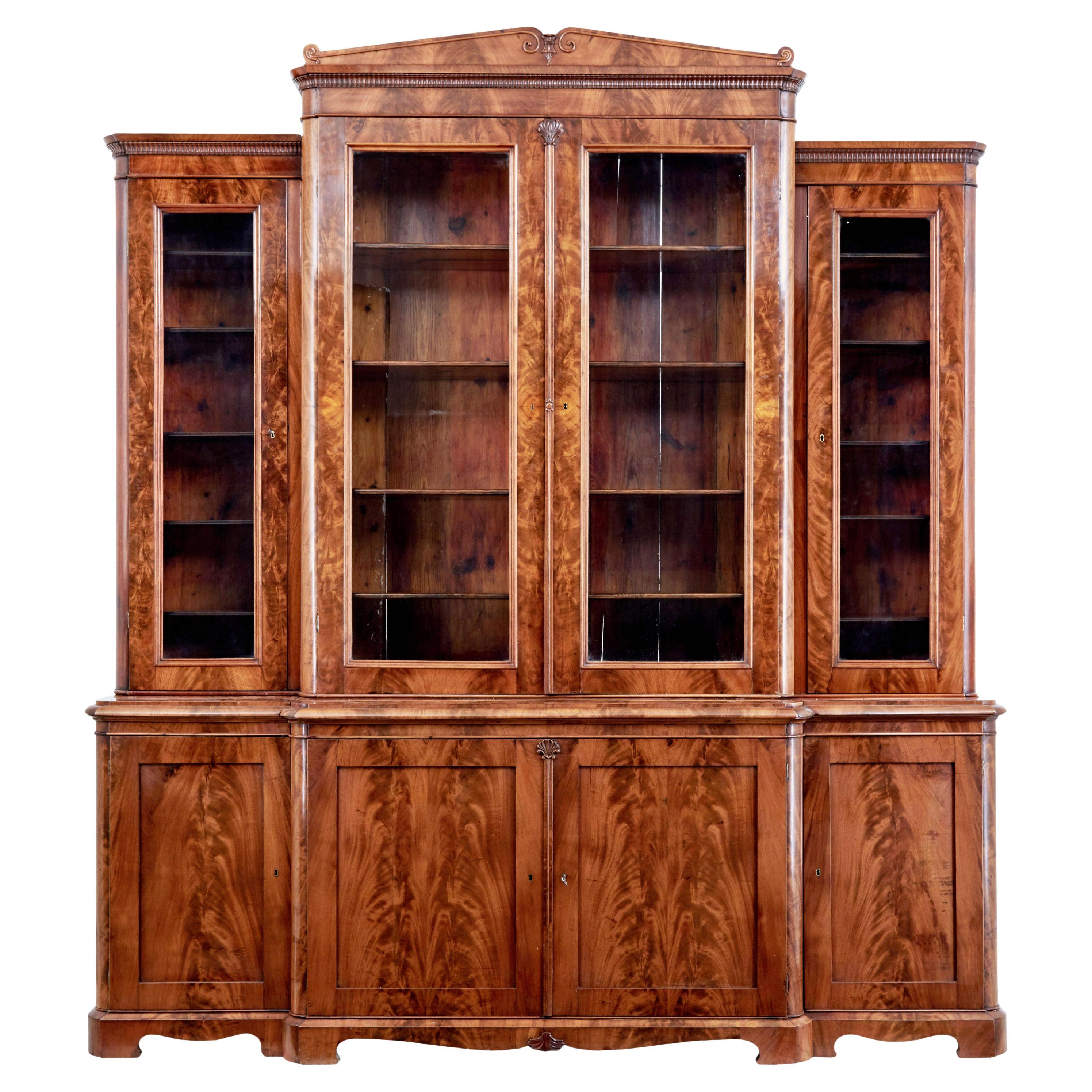 Early 19th century Scandinavian empire flame mahogany breakfront bookcase For Sale