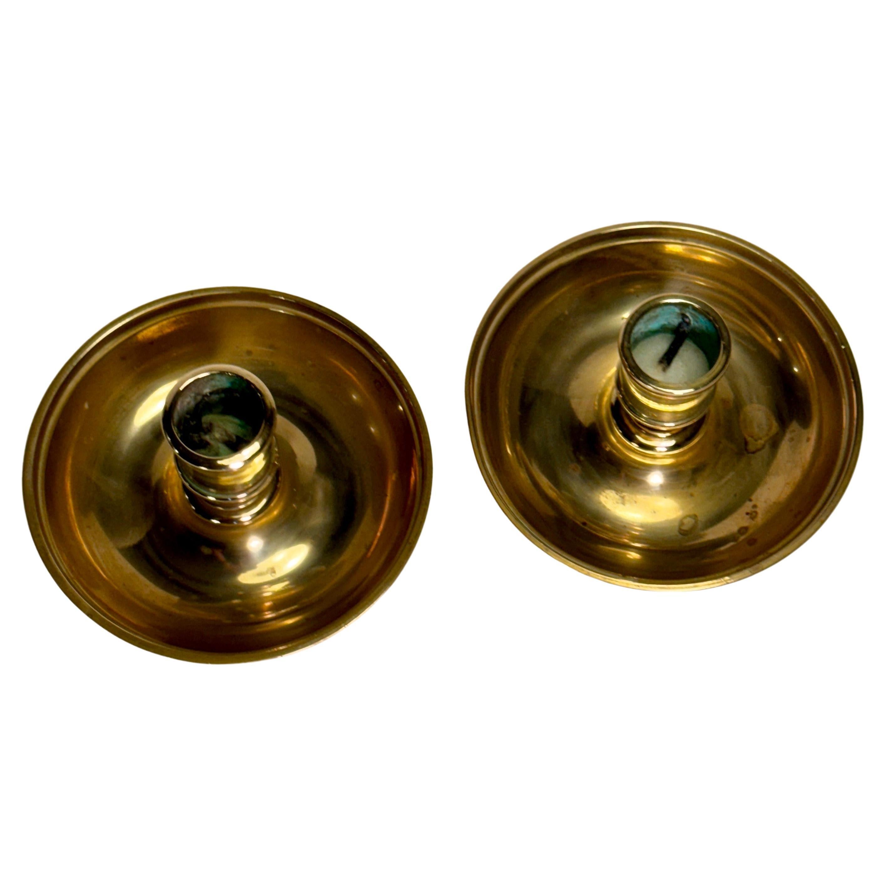 Set of two small travel candlesticks in brass. The set can easily disassemble into 4 parts, two bases and two candleholders. The four parts can then be assembled into a pair of candlesticks. This neat little trick makes them perfect for travel and
