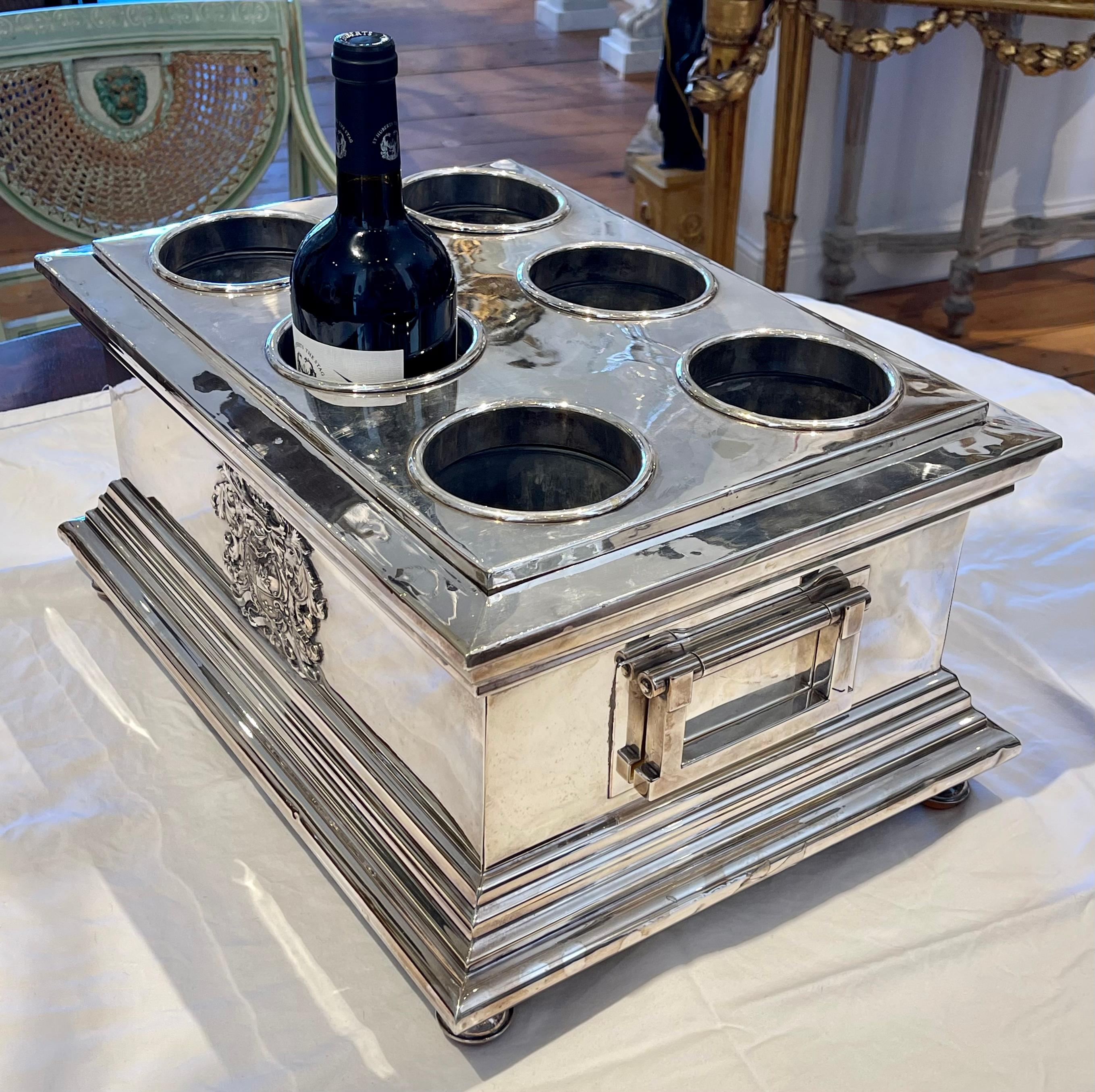 Rare Sheffield Silver Plate Six Bottle Wine Cooler.  Armorial on both sides.  Ball Feet.  Handles.  Top lifts of to hold ice for chilling of wines.

Provenance:  Palm Beach Collection.  Fresh to Market