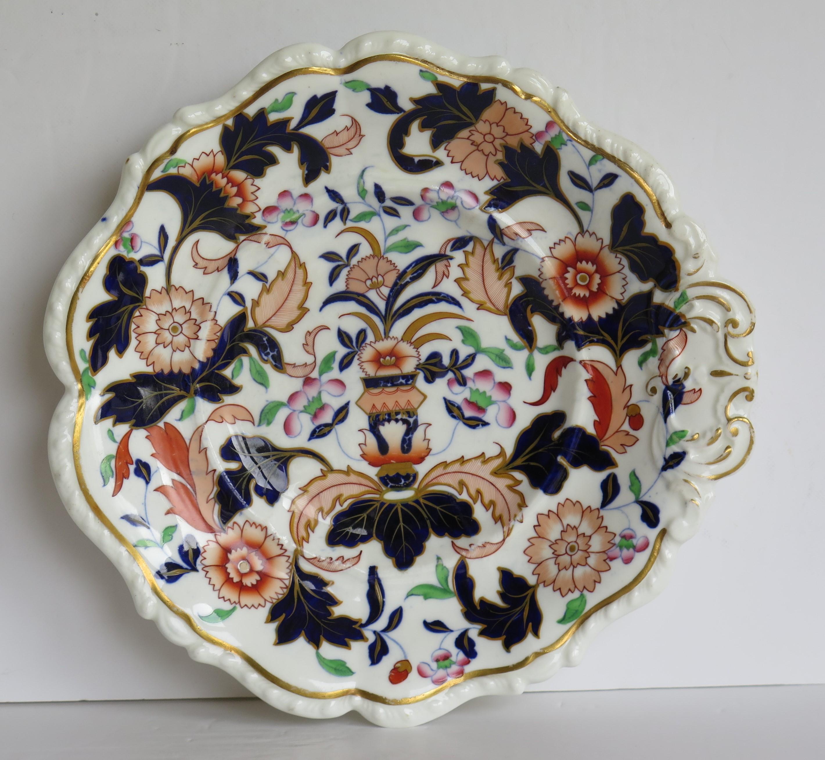 This is an early 19th century porcelain desert dish with a fluted shell shape, made by one of the Staffordshire, English potteries and dating from the George 111rd period, circa 1820.

This piece is unmarked to the base but we believe it is very