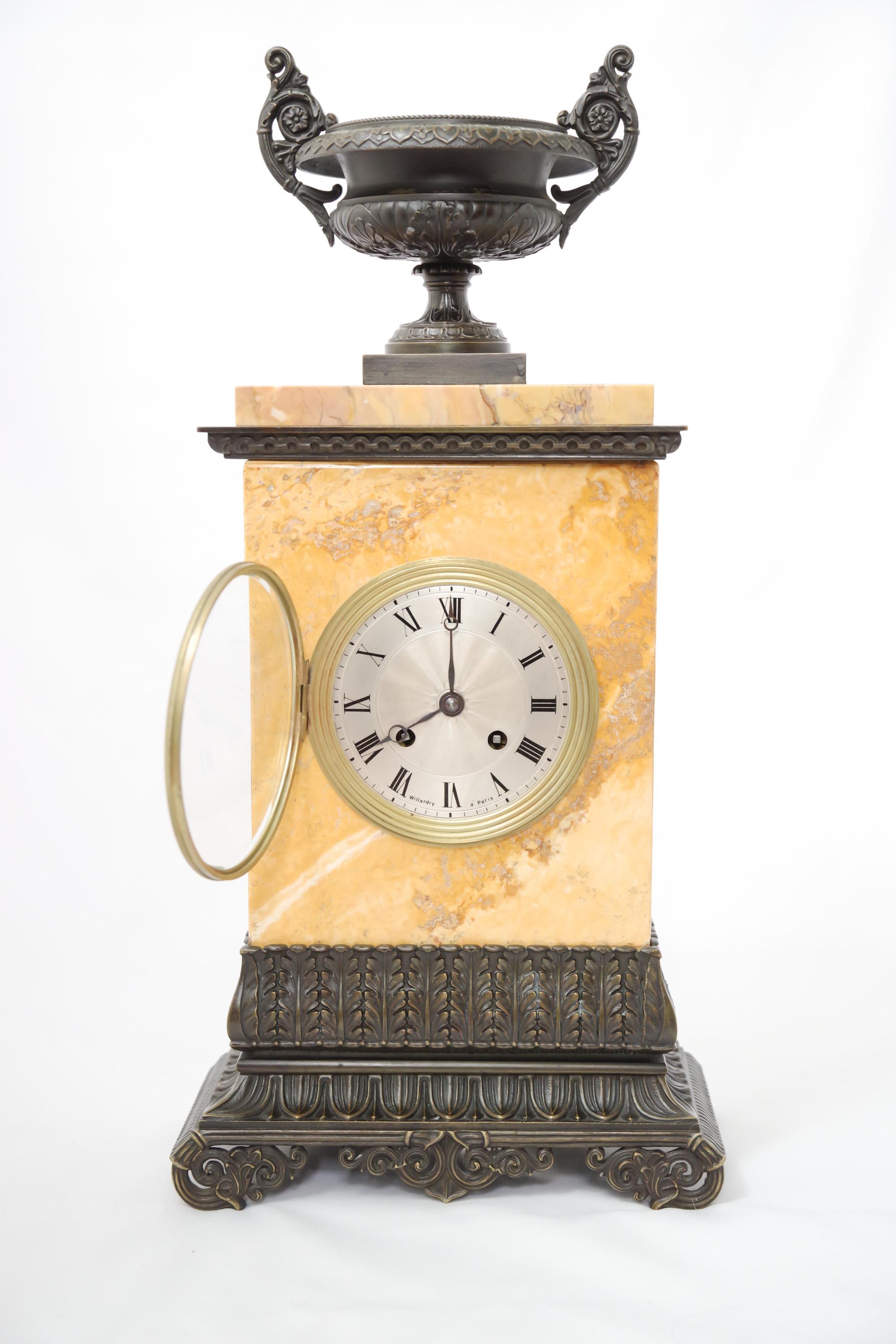 A French Sienna marble and patinated-bronze portico clock, Restauration Era, 1815-1830. The silk-thread mechanism is in good working condition with key and pendulum.