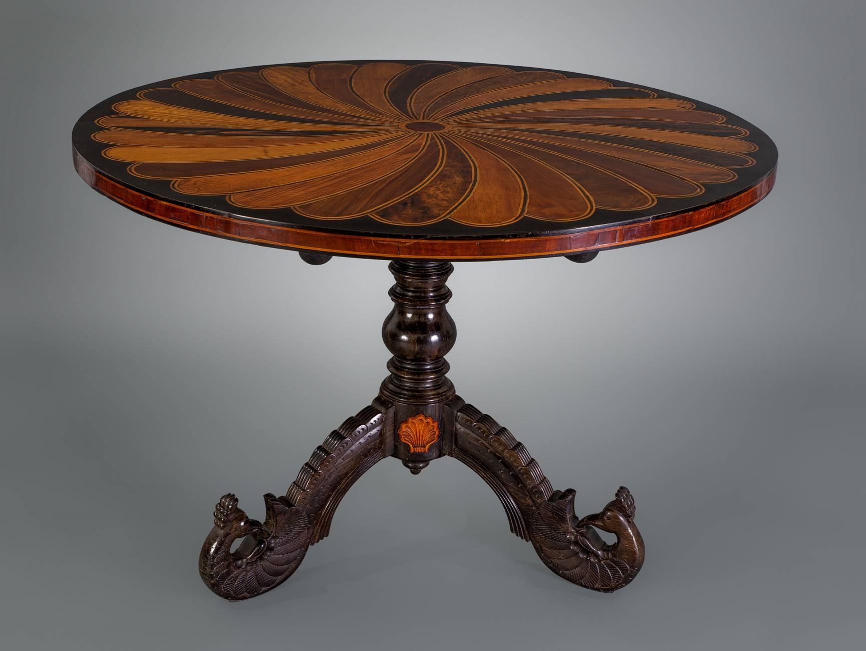 A particularly fine example of these striking tables from the Galle District of what is now Sri Lanka. The tilt-top with a swirling design in multiple specimen woods above a twined baluster standard, raised on stepped and carved cabriole legs