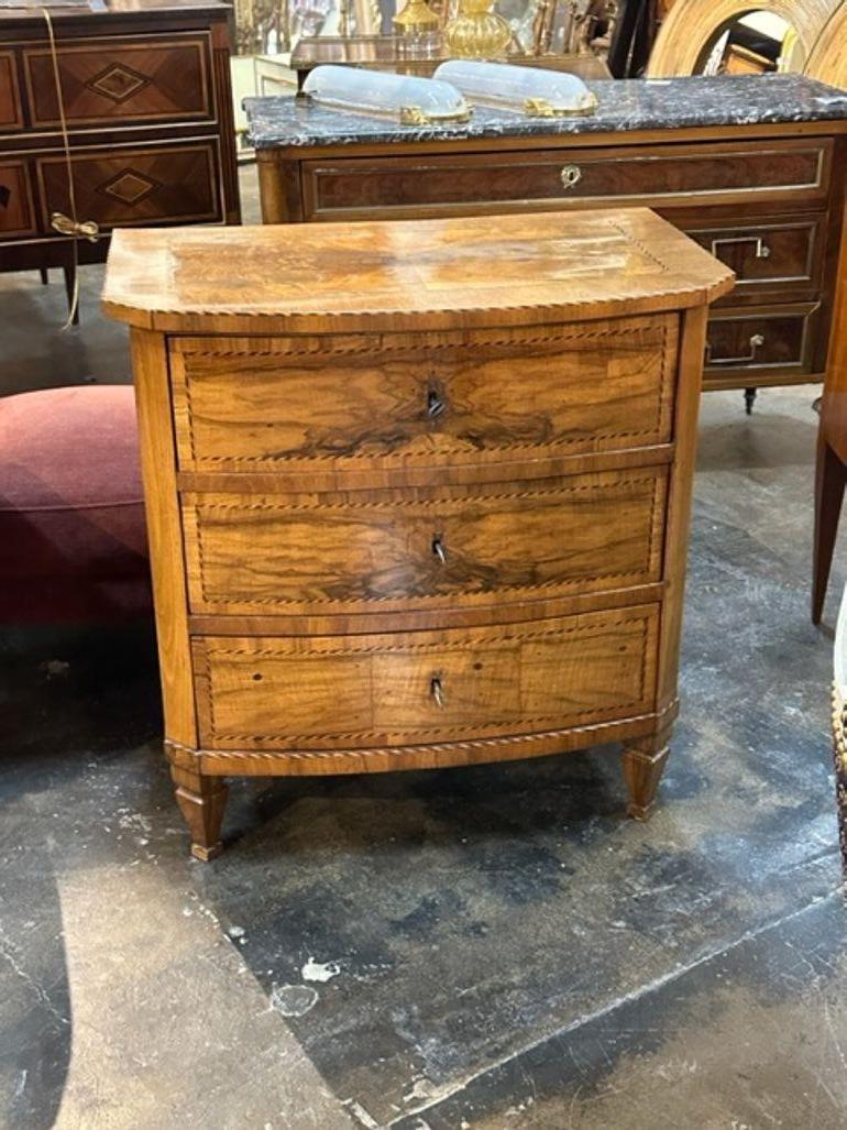 Handsome early 19th century German inlaid walnut bowfront chest. Featuring a gorgeous finish and a nice pattern on the drawers and top. Lovely!