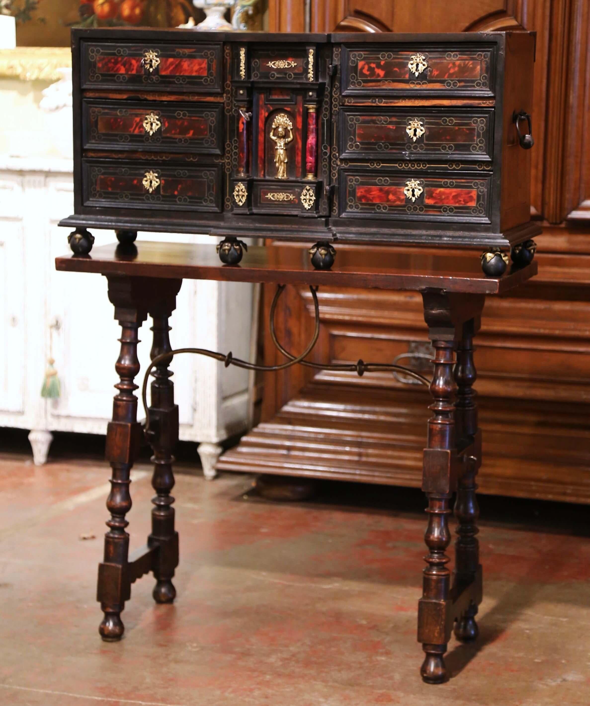 This elegant, antique two-piece Bargueno or Vargueno was crafted in Spain, circa 1820. The cabinet standing on round feet sits on a table base with carved turned legs and embellished with a decorative wrought iron stretcher. The cabinet with side
