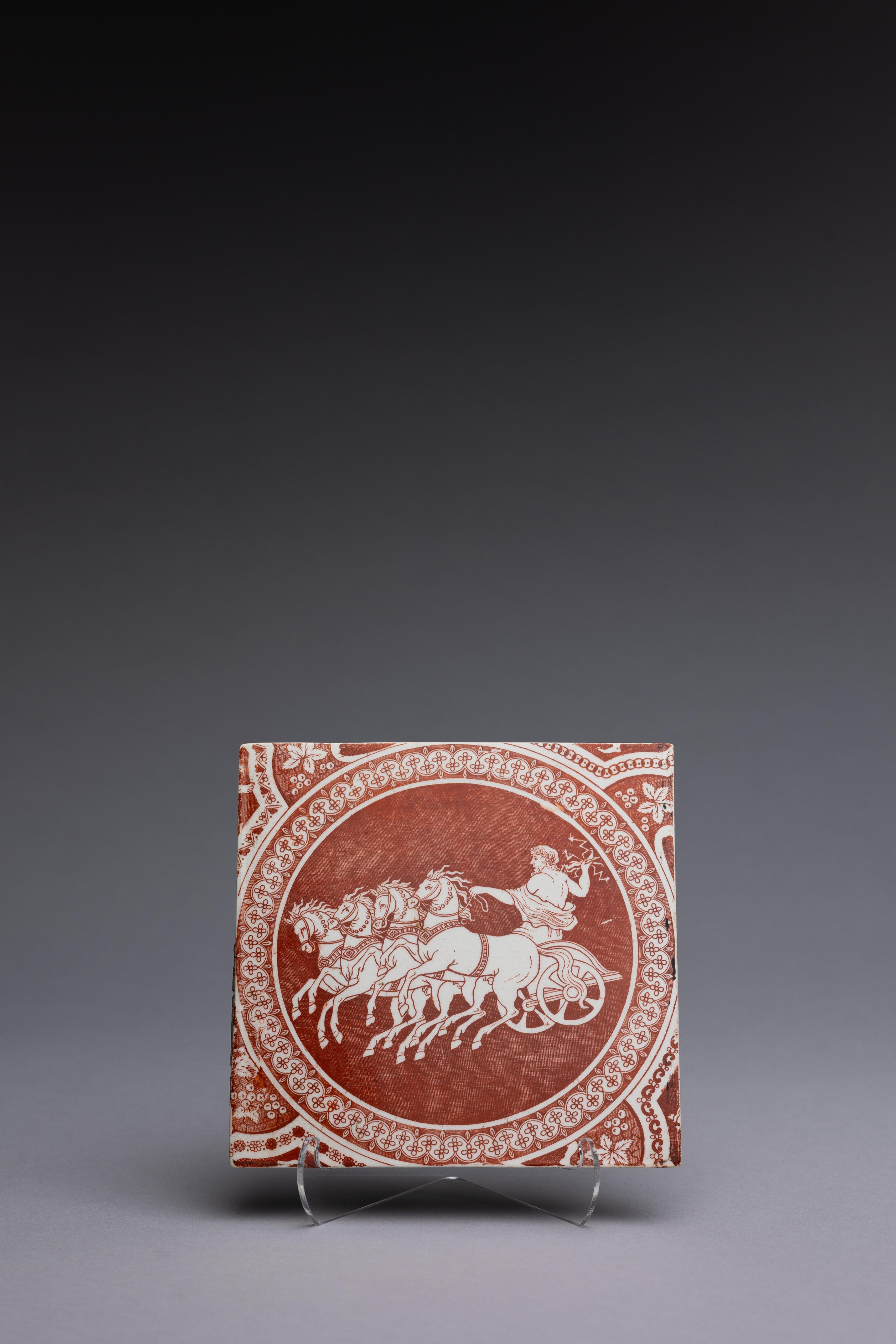 A Neoclassical red transferware tile made by Spode 1806-1810, with the ‘Zeus in His Chariot’ pattern.

Sir William Hamilton’s Collection of Etruscan, Greek and Roman antiquities, first published in 1766 by Pierre d’Hancarville, was a landmark