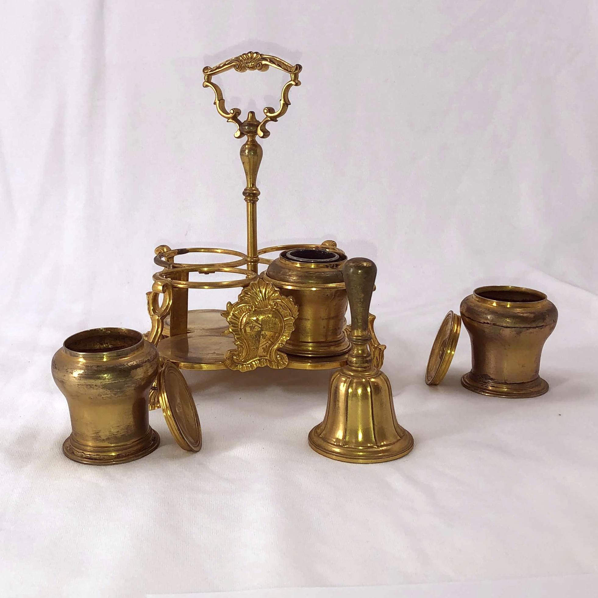 An early 19th century English gilt bronze desk set Standish with handle, cartouche mount, and unusual shell form feet.