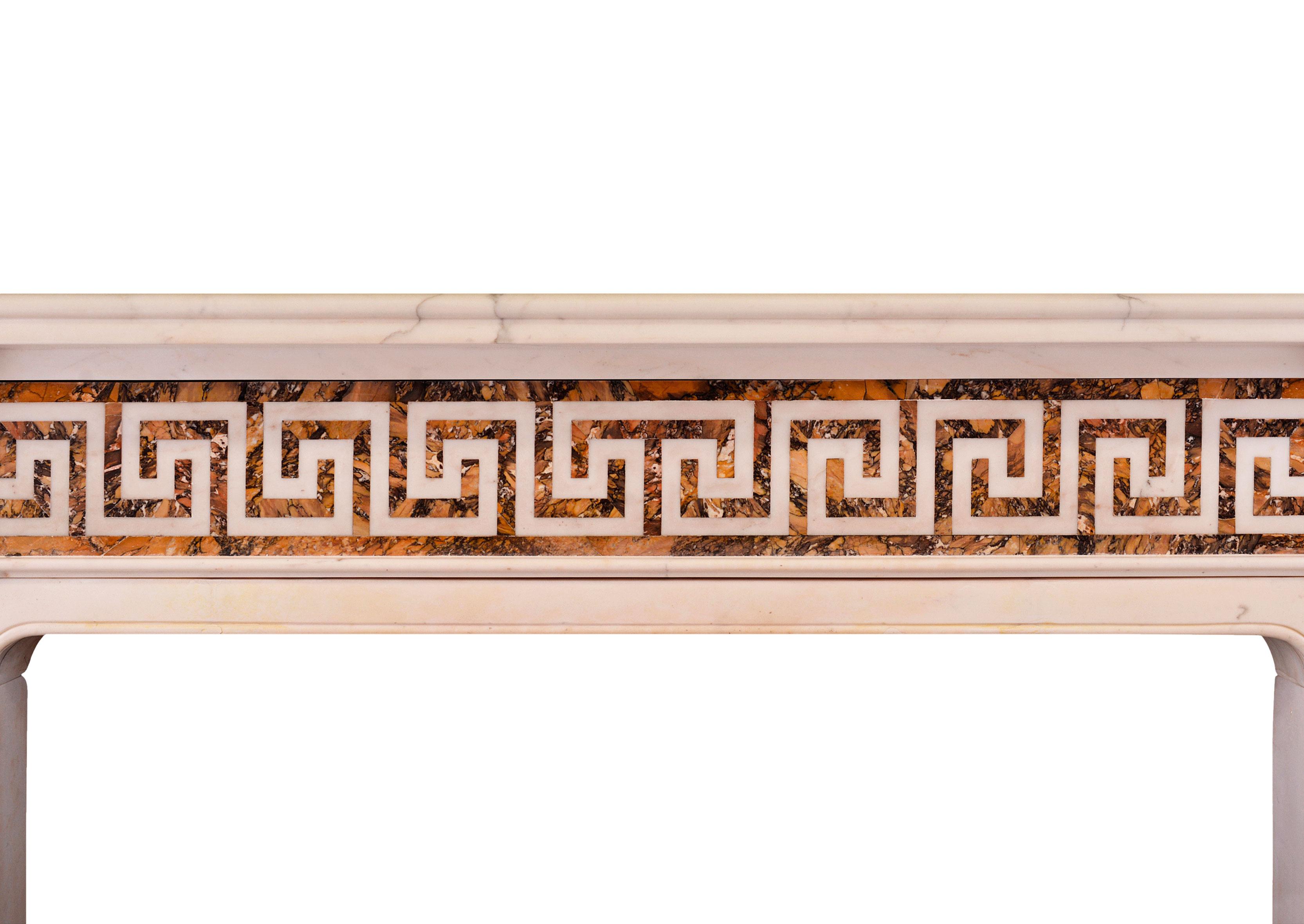 A good quality late Georgian antique fireplace. The statuary jambs inlaid with Italian Siena marble, surmounted by carved end blocks featuring Anthemion palmette. The Greek key frieze with matching inlaid Siena marble with moulded shelf above.