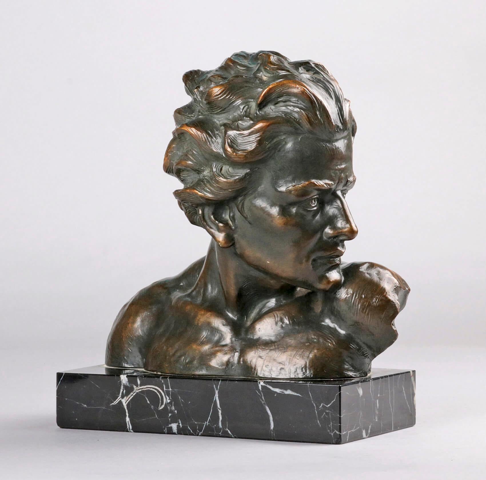 Beautifully expressive statue from the Art Deco period, bust of a young man. The statue is made of terracotta with a black marble base. The statue is patinated in a green bronze color. On the back is the signature of the artist, Johannes Dommisse,