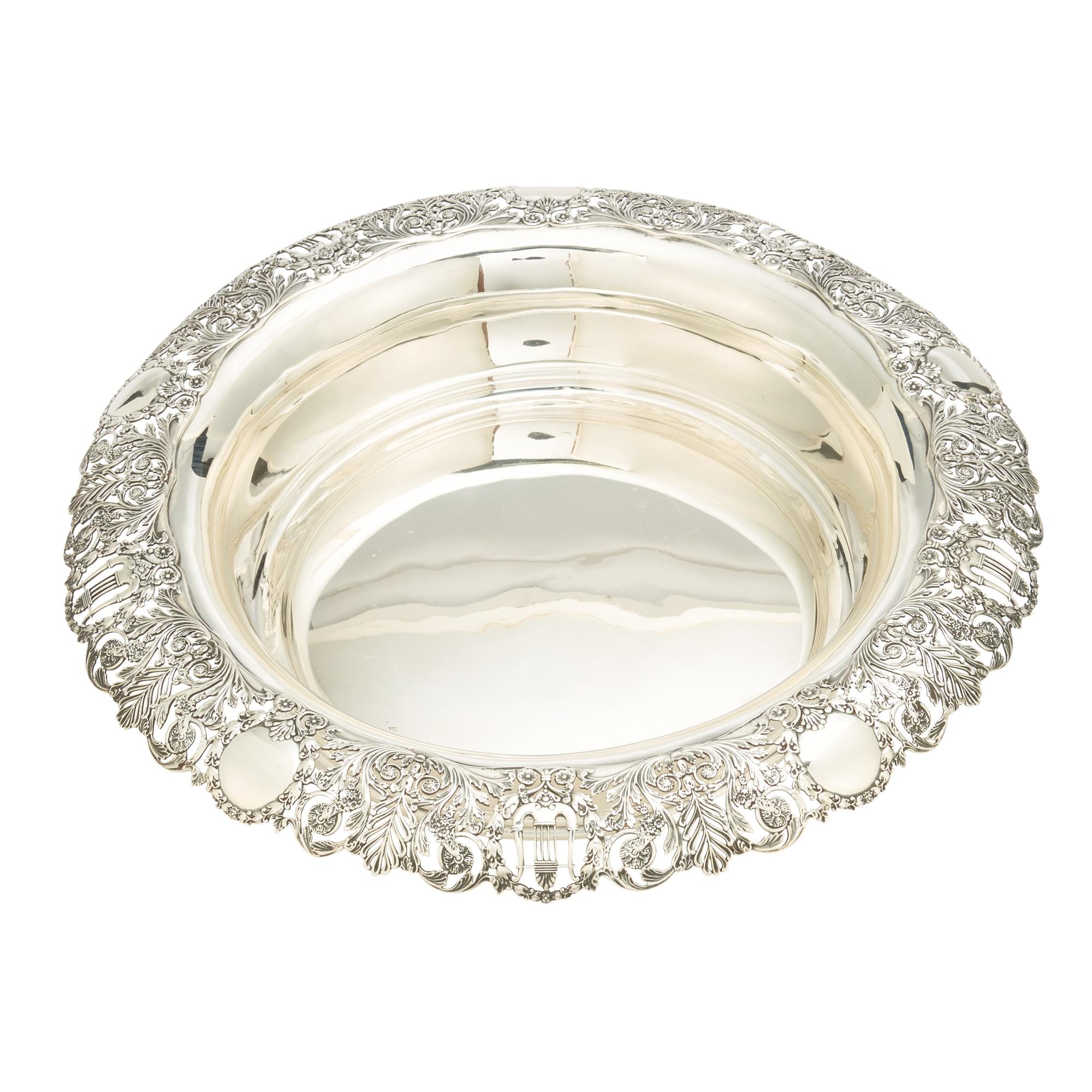 Indulge in the timeless elegance of this early 19th-century sterling silver tableware centerpiece, crafted in the United States by B. Starr. This exquisite piece features a circular shape with an everted decorated rim, adorned with an openwork