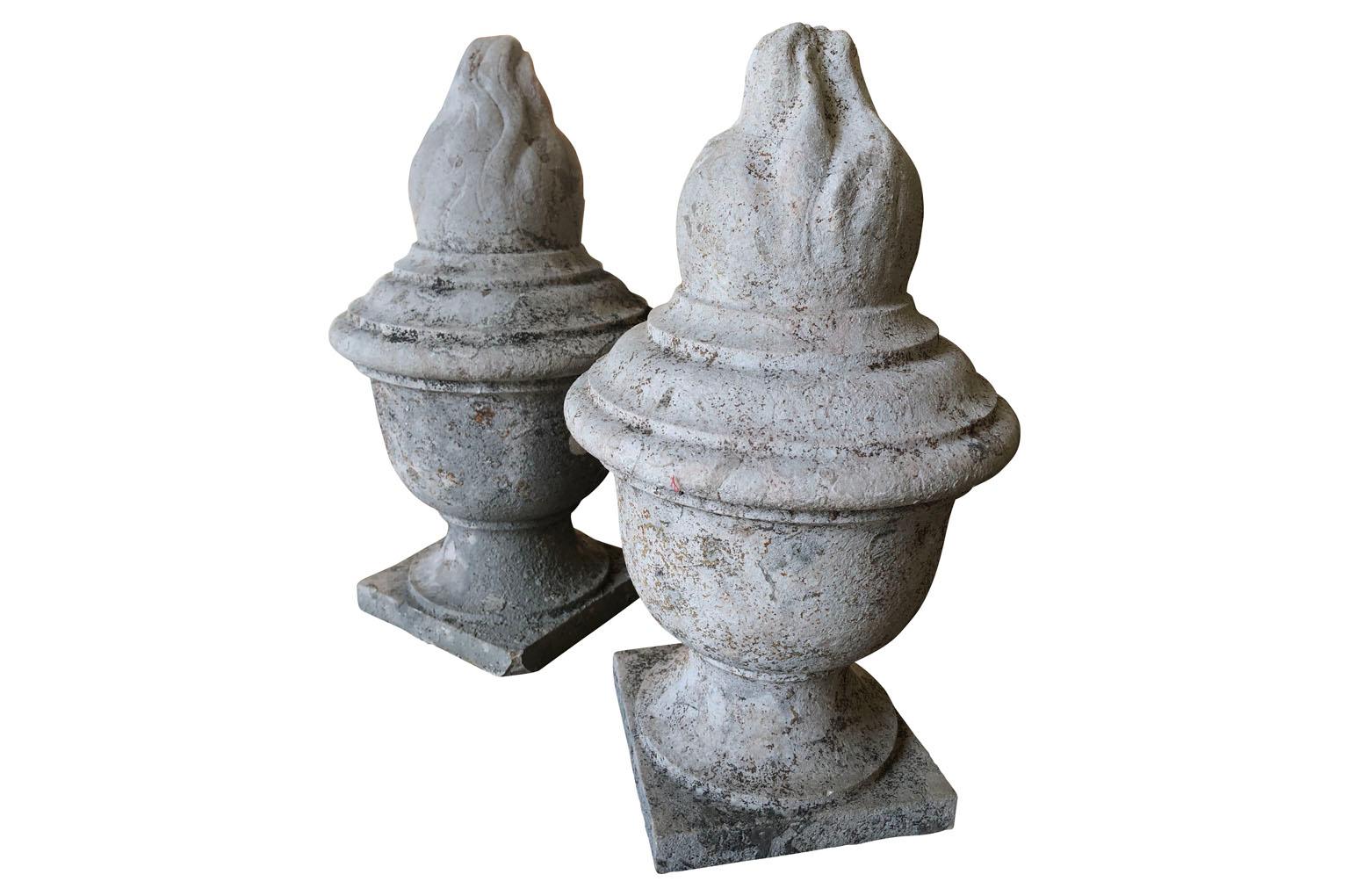 A stunning pair of early 19th century Flambeaux - Flame finial statues - expertly carved from Pierre De Bourgogne - stone from the Burgundy region of France. The flame represents eternity. Wonderful patina. Perfect for any interior or garden.