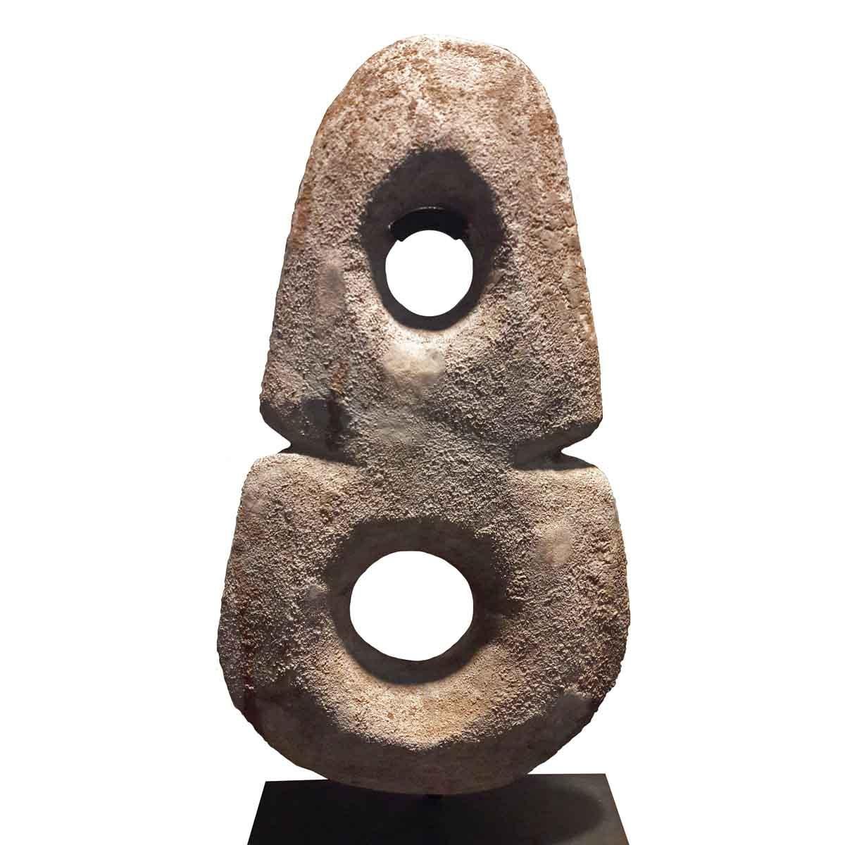 A large vertical sandstone disk sculpture, representing the Yin and Yang symbol. Liaoning, China, early 19th century. Mounted on a metal stand.
 