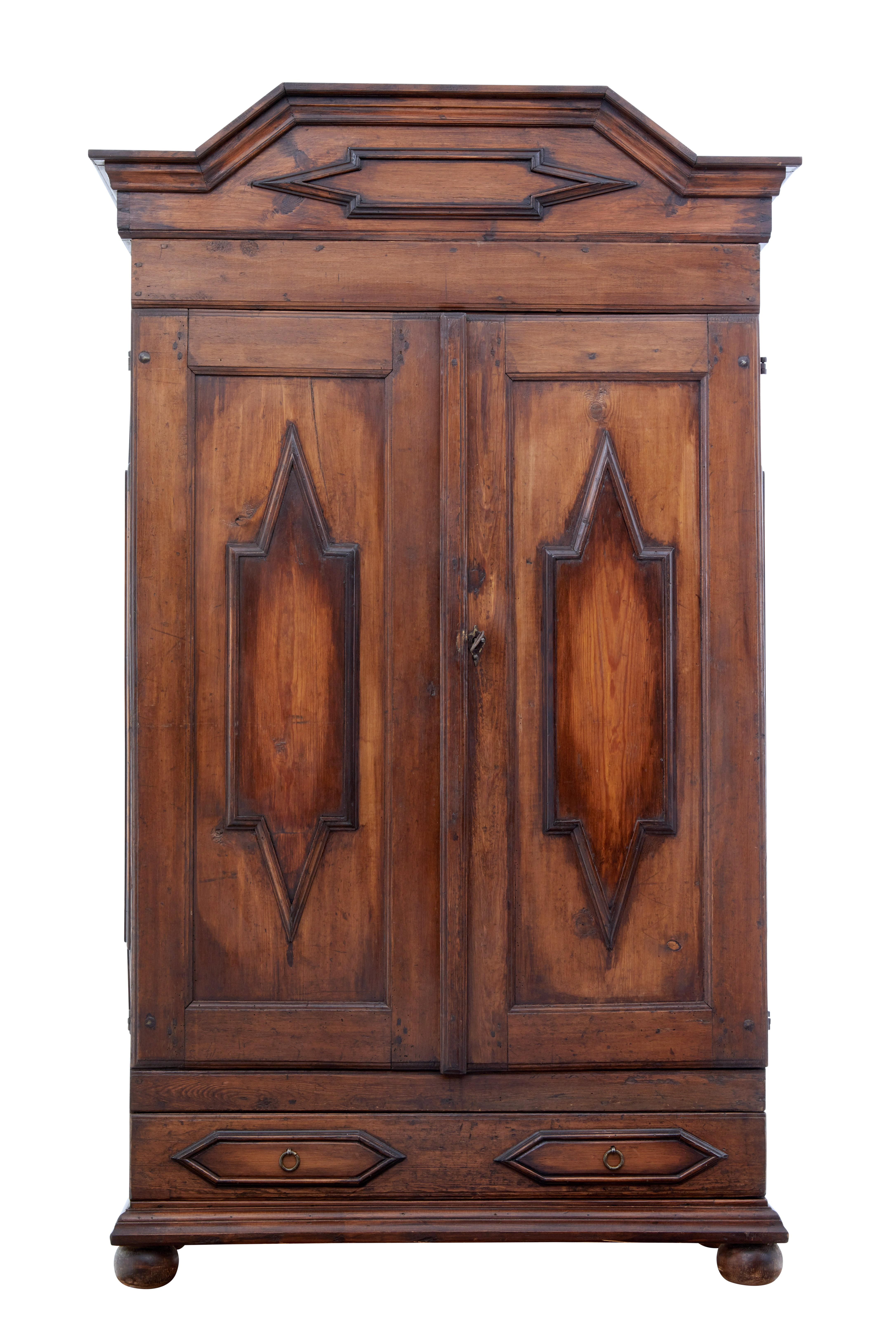 Striking Swedish Baroque pine cabinet circa, 1810.

Double door cupboard with applied angled motifs, these are repeated on the sides and on the cornice.

Cornice is removable, allowing this piece to be easier to install and ship. Dark stained