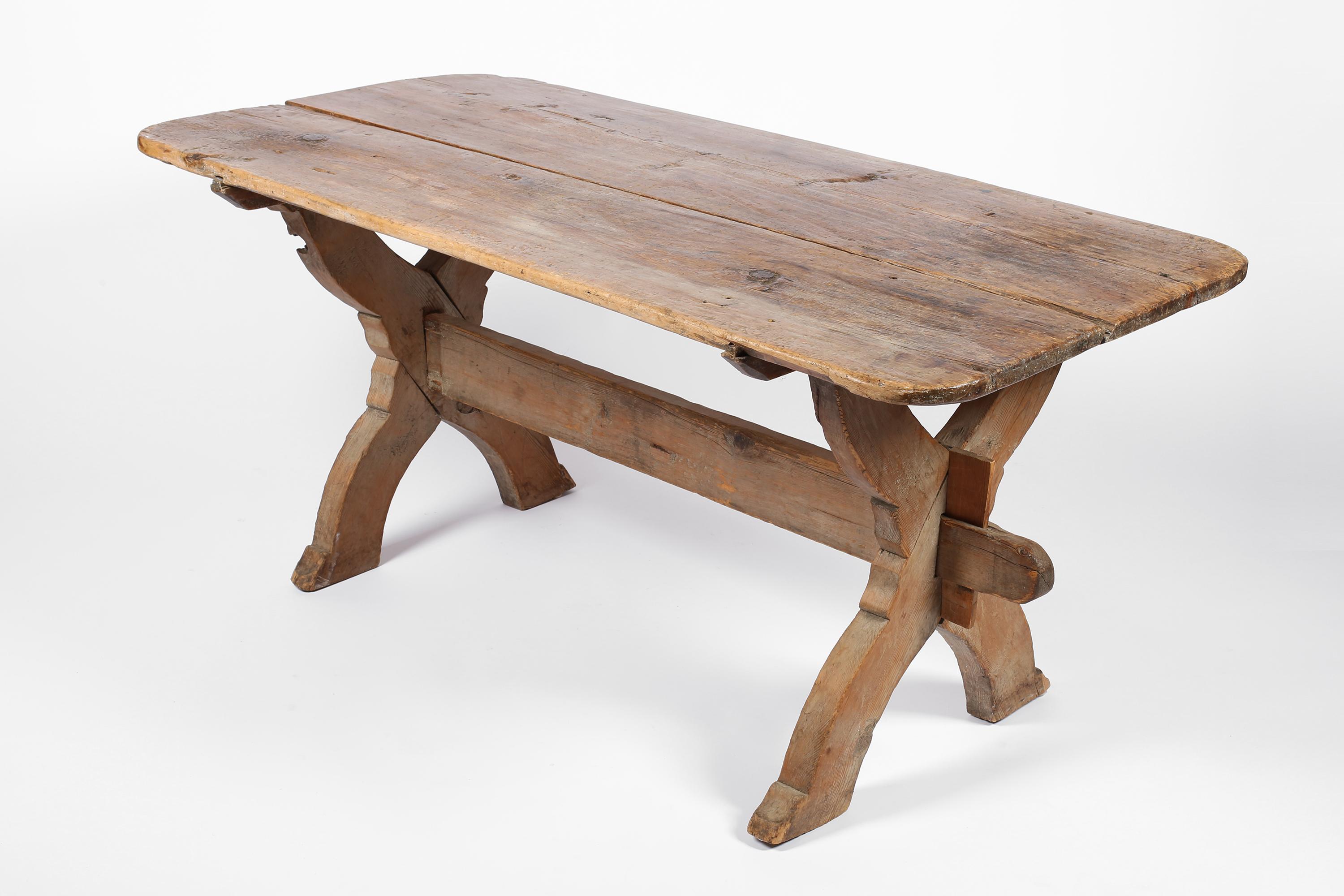 A charming early 19th century ‘bockbord’ dining table in heavily patinated pine timber. Featuring carved cross supports and a central stretcher fixed with pegs. To comfortably seat six, or suitable to be used as a centre/console table. Swedish, c.