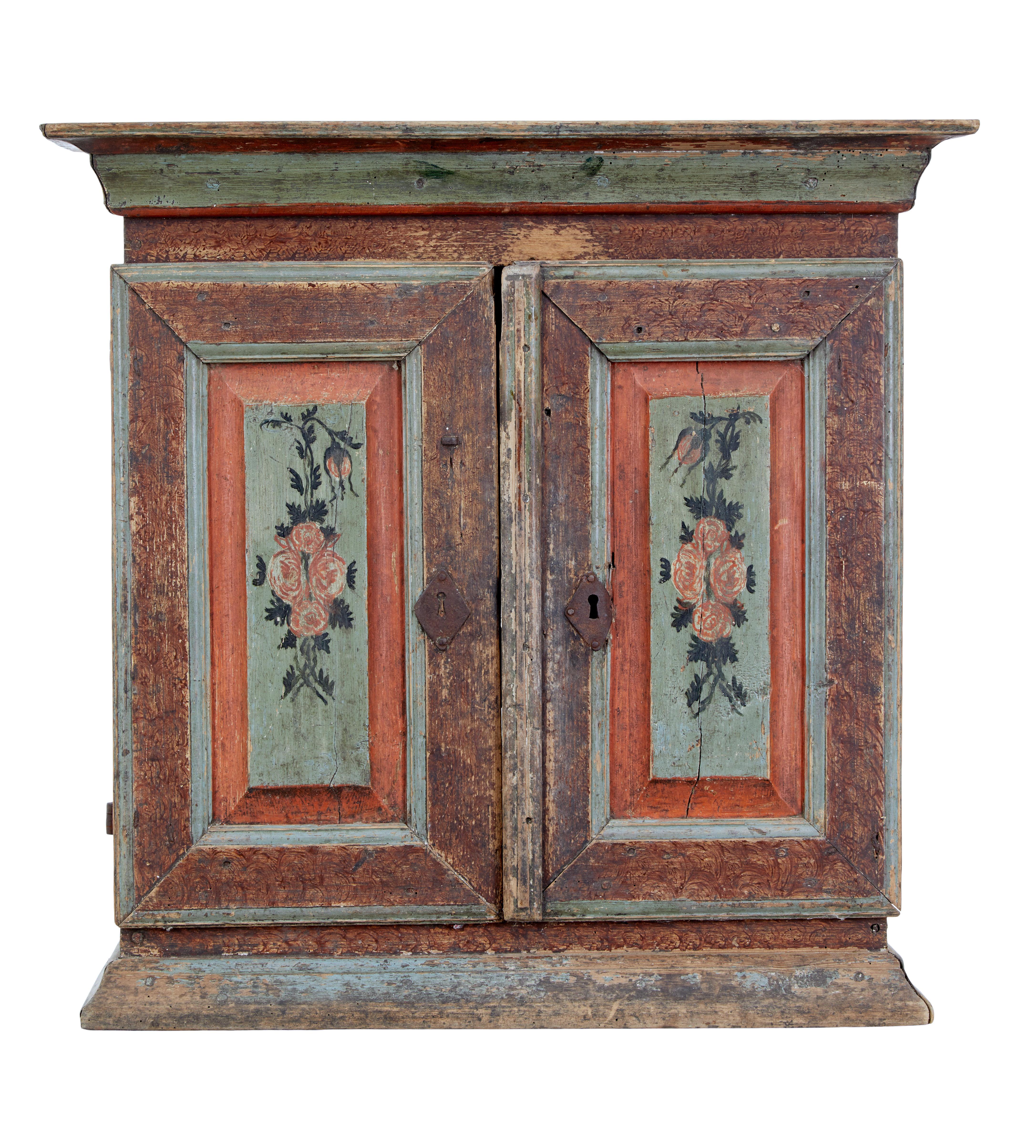 Early 19th century Swedish folk art painted cupboard circa 1820.

We are pleased to offer this Swedish traditional hand painted cupboard in original condition, which would of been hung or placed against a wall on a table top.

Original green and