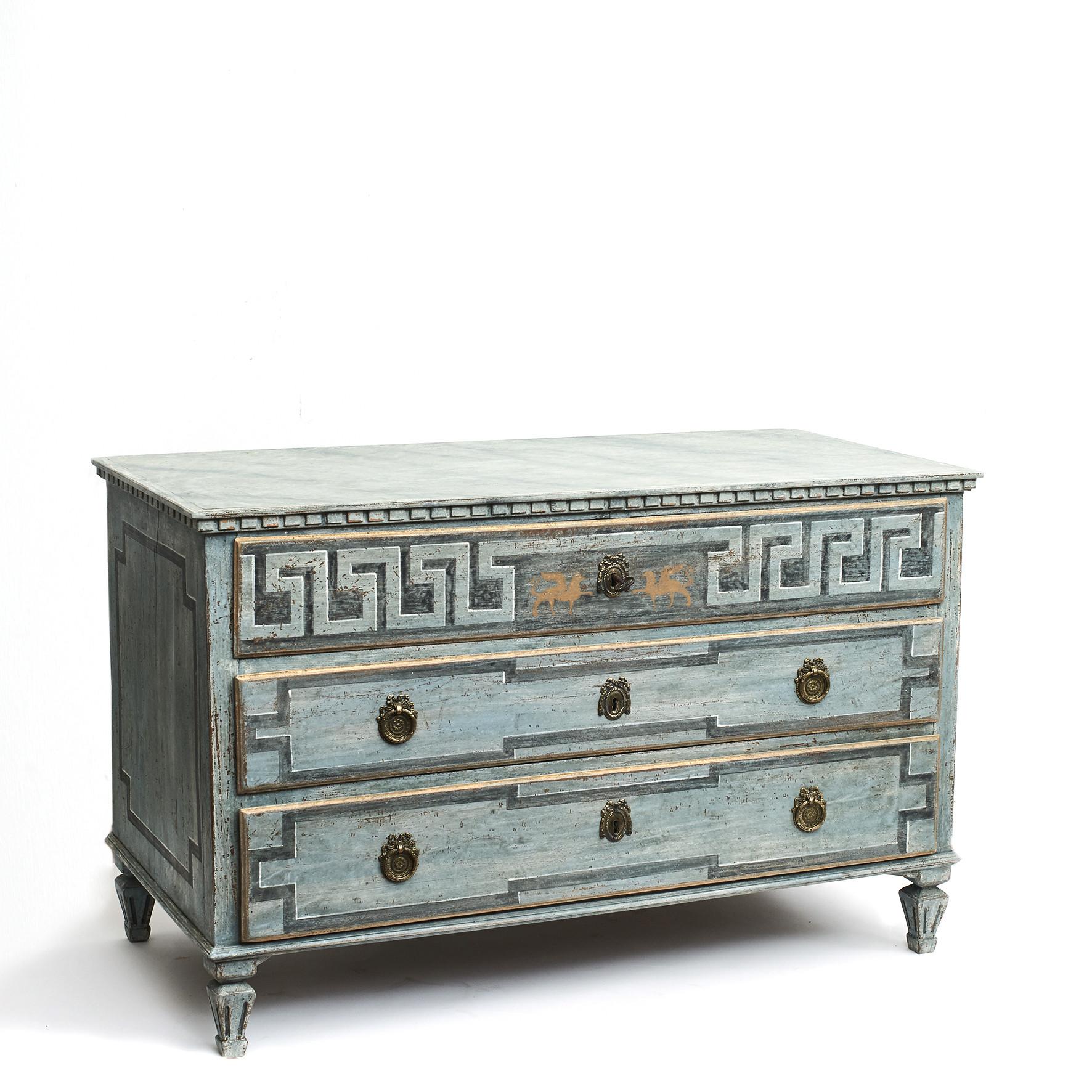 Swedish Gustavian chest of drawers painted in blue shades. Wooden gray marbled tabletop.
Three drawer, upper drawer decorated with 