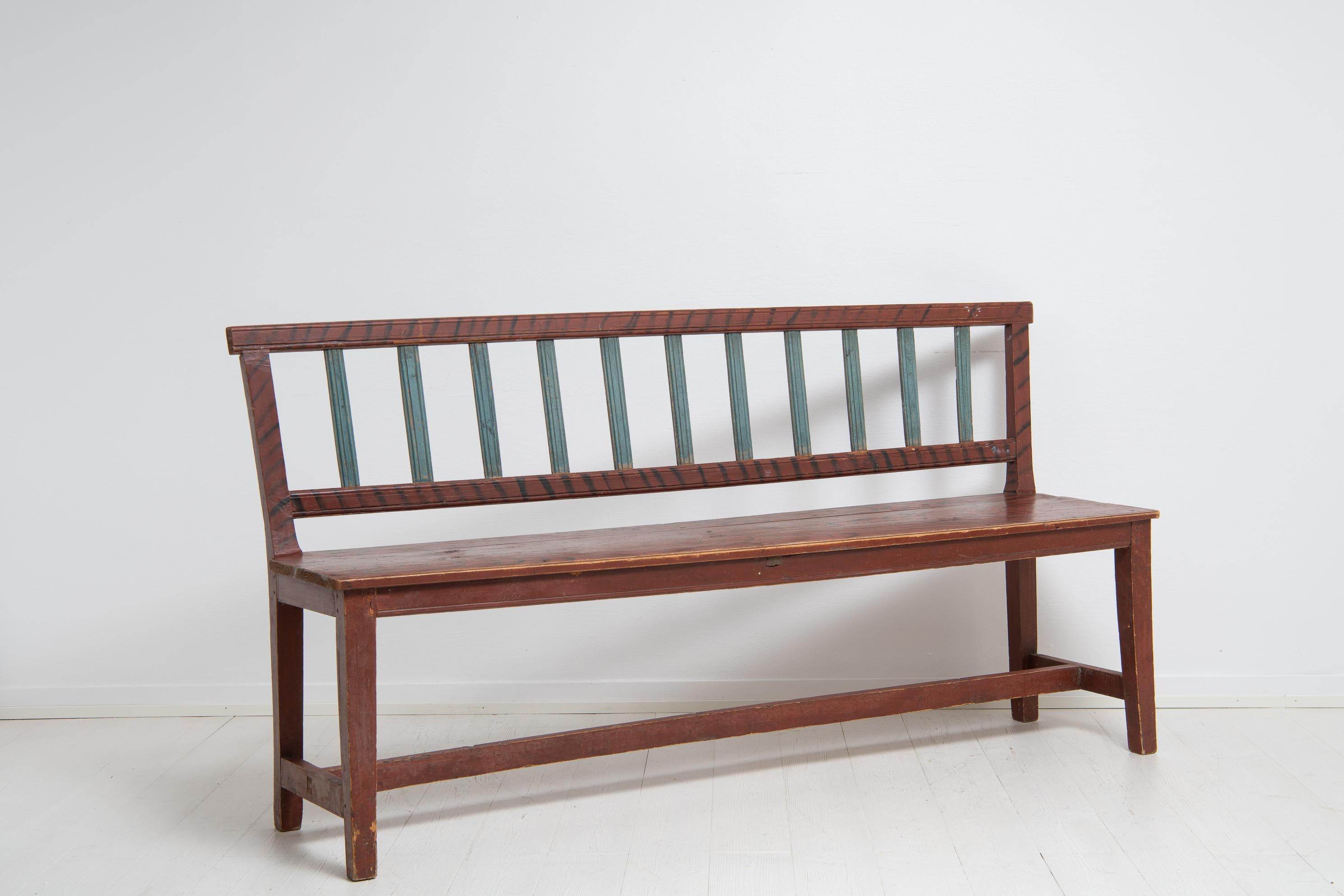 Swedish gustavian country sofa or bench from the early 19th century. The sofa is a country house furniture in folk art with an unusual straight shape. The sofa has profiled or fluted ribs in the backrest and all original paint. The red paint has
