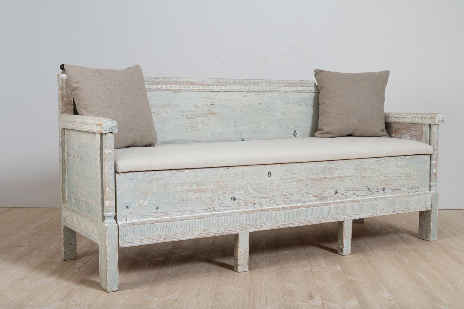 Gustavian Provincial sofa from northern Sweden. The sofa is hand scraped to the original light blue / green paint. Decorated with carved wooden decor over the back and lower section. 

The space under the seat is favourably used as extra storage