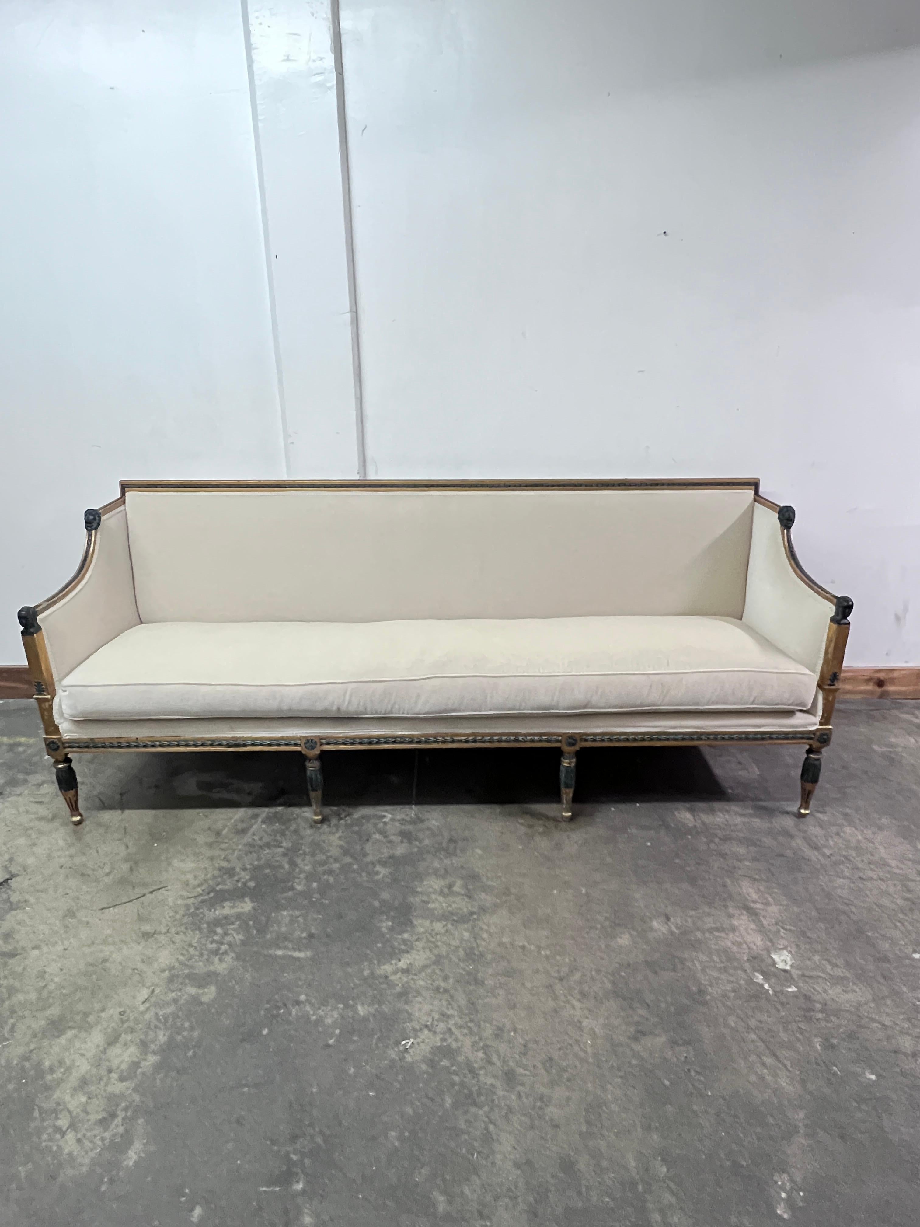 Fine 19th century late Gustavian sofa inspired by the Roman Empire and ancient Egypt. Hand Crafted with Gold Leaf Wood Trimmed Hand-Carved Rosette Details.  The removable back allows for easy reupholstery and for the sofa to convert to a window