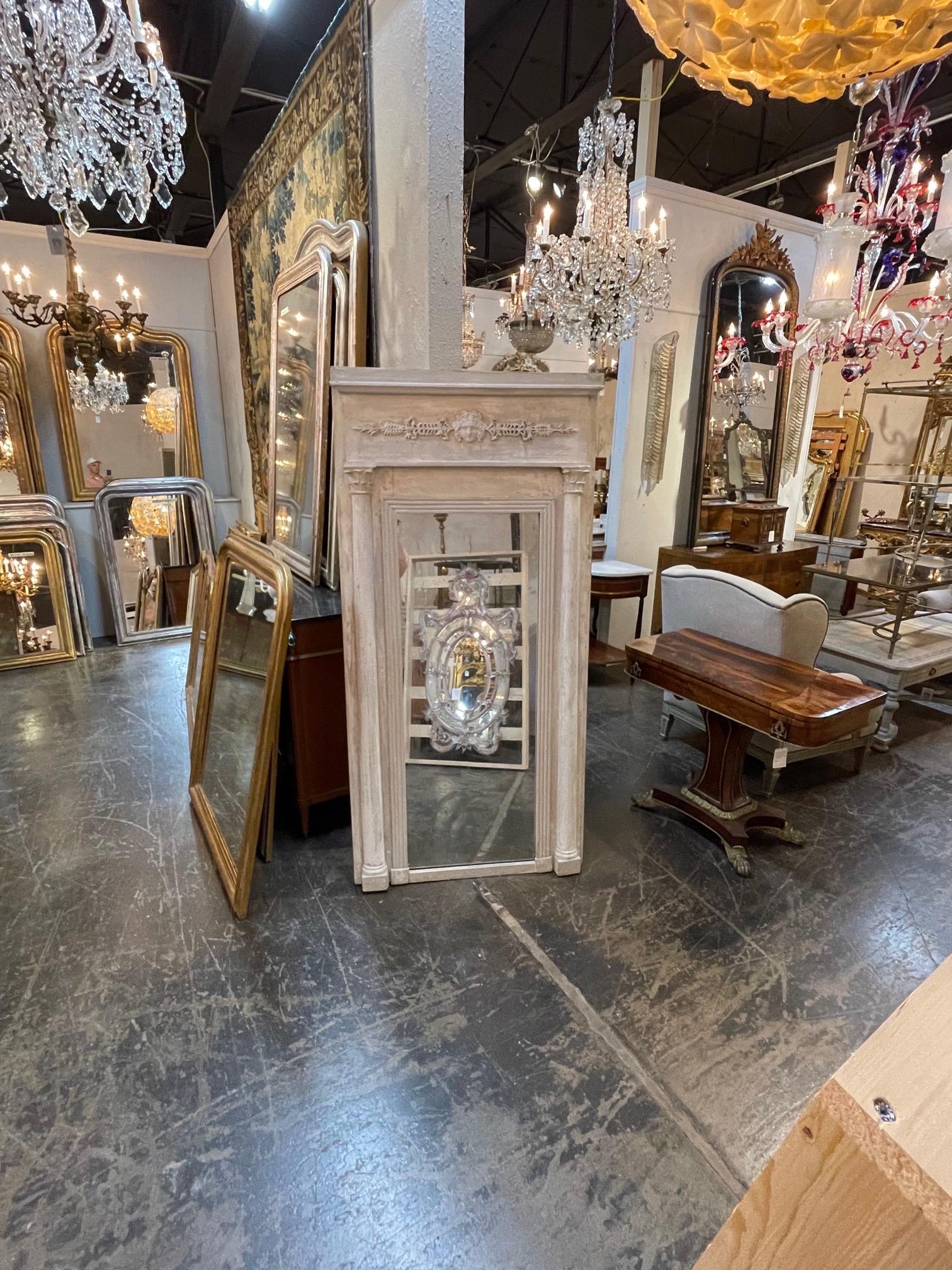 Large scale decorative early 19th century Swedish neoclassical painted mirror. Note the beautifully carved face at the top of the mirror. Makes an impressive statement!