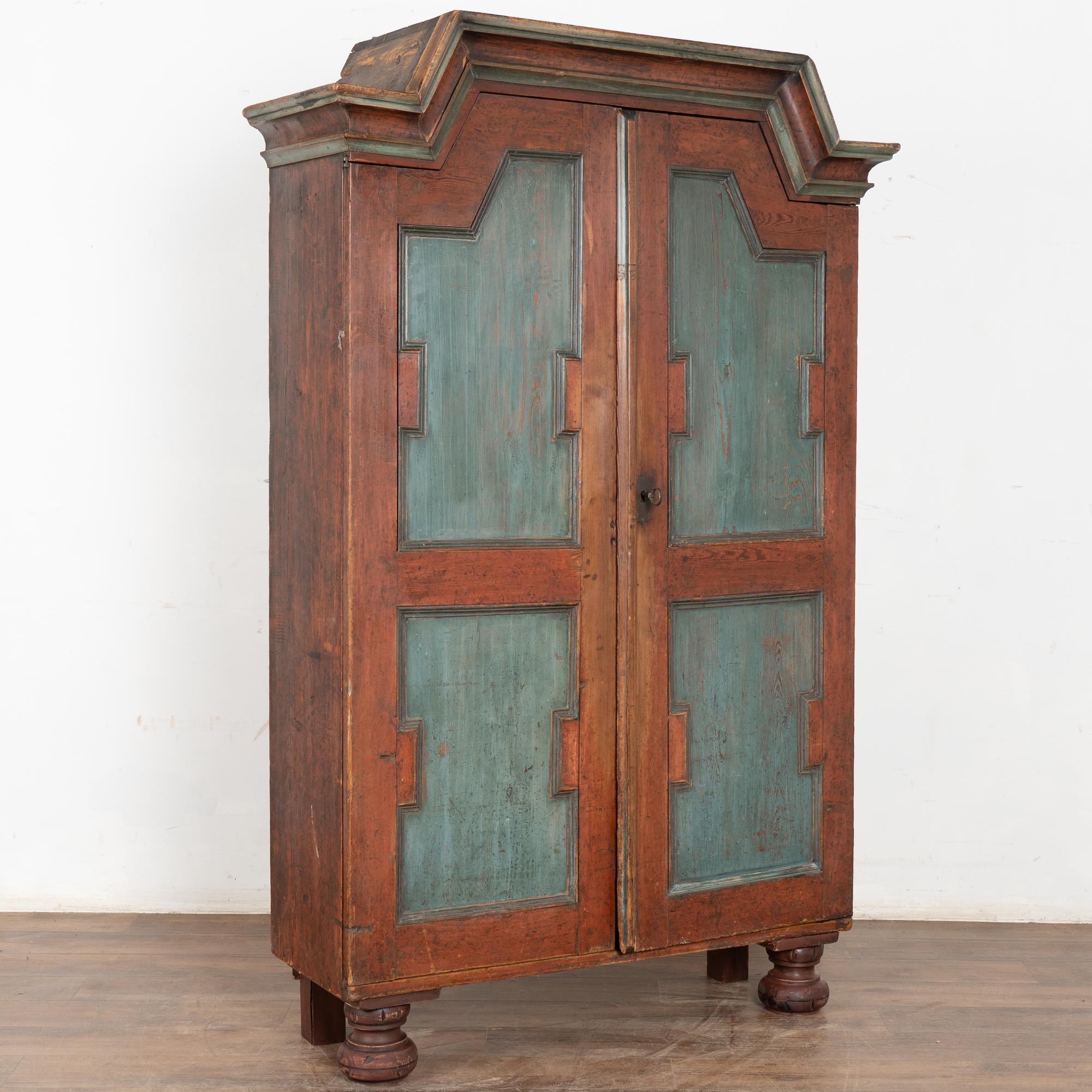 Swedish original painted pine armoire with blue panels and trim, standing on aged bun feet.
The original painted finish has been distressed through generations of use, resulting in the deep patina of this delightful cabinet standing just over 6'