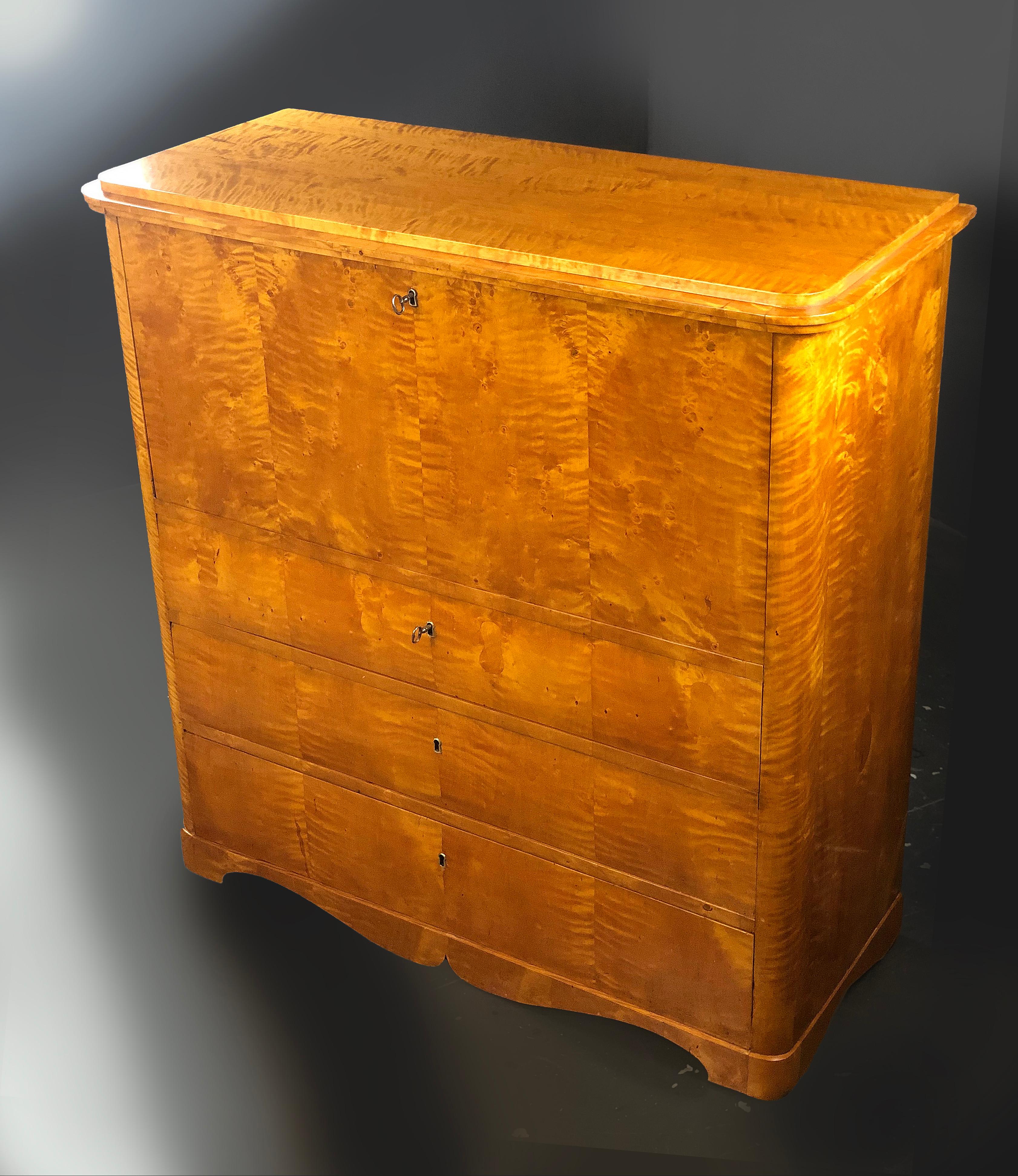 Attractive honey colored satin birch Secretaire Biedermeier of Swedish origin with lovely rounded front corners and a large fall front that when open, it offers a large writing surface and stays horizontal so that it may be used for placing