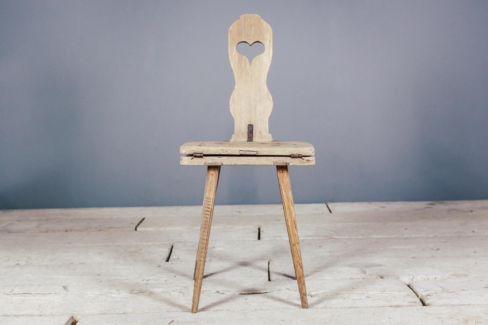 Primitive love token metamorphic chair table or Bordstol, naive love heart carved into the back splat. Unusually delicate and refined tapered legs.
Measurement as a table 56cm High, 87cm wide, 48cm deep.
Dimensions: 48cm x 110cm x 44cm.
