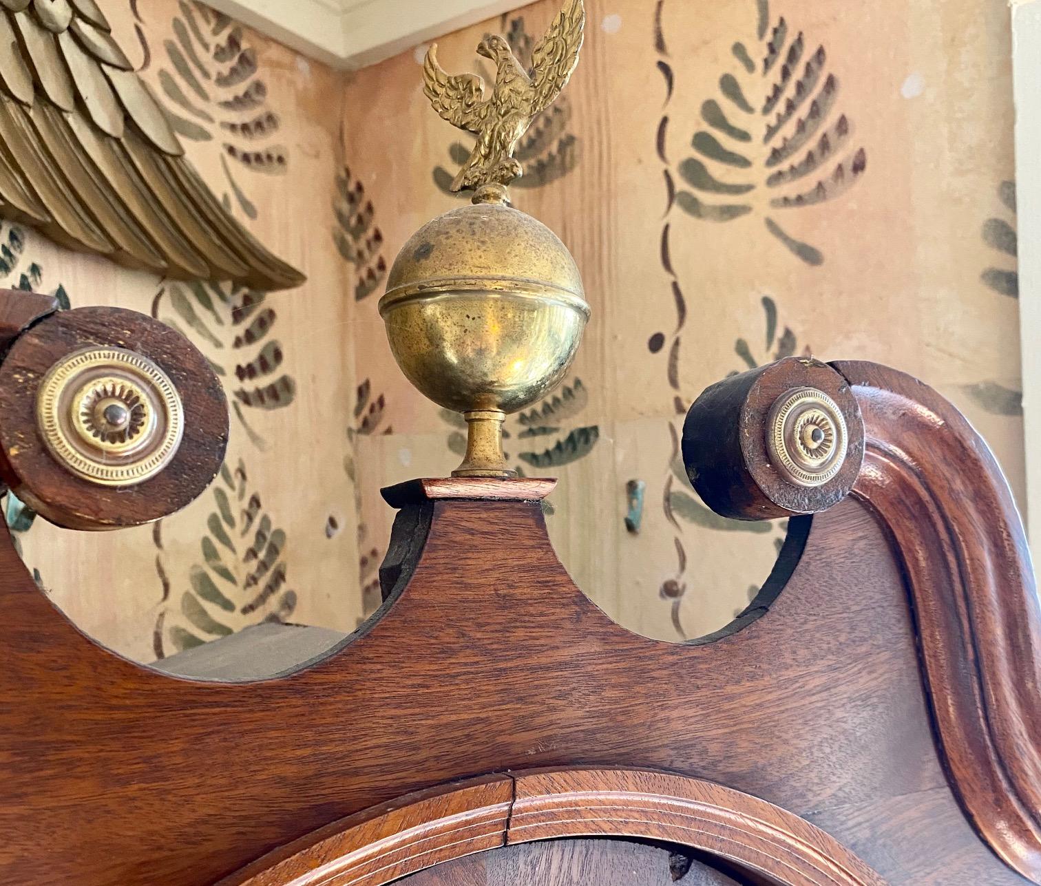 Early 19th century tall case clock by James Hogg, from village of Gifford near Edinborough, circa 1820, with fine mahogany case, brass finial on swan neck pediment, tombstone glazed door flanked by reeded columns with brass capitols, revealing a