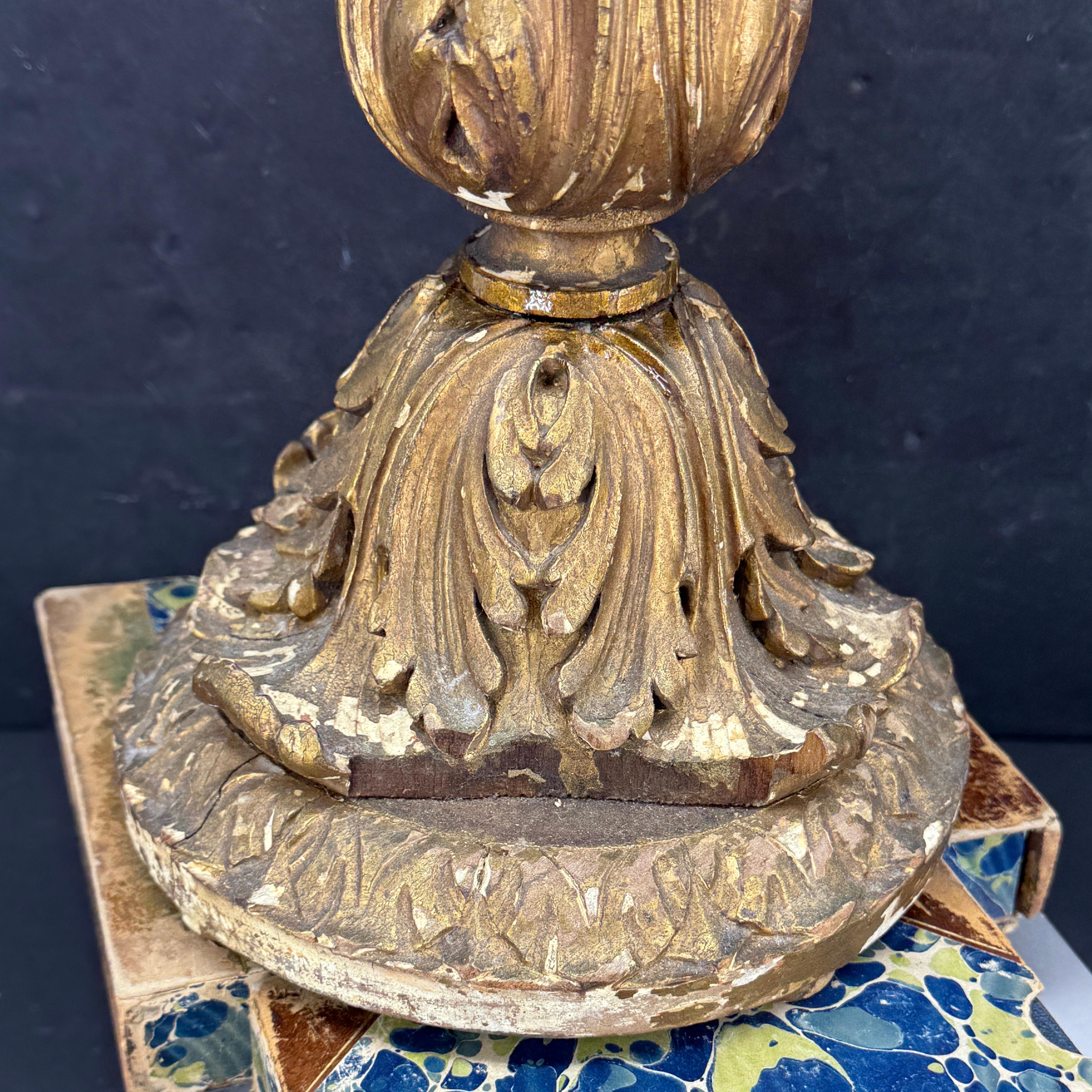 Carved wood gold gilded alter candlestick with original patina. This tall candlestick is carved from wood and has a flat top to hold a pillar candle. Wonderful addition as a stand alone display piece or would be fantastic as part of a collection on