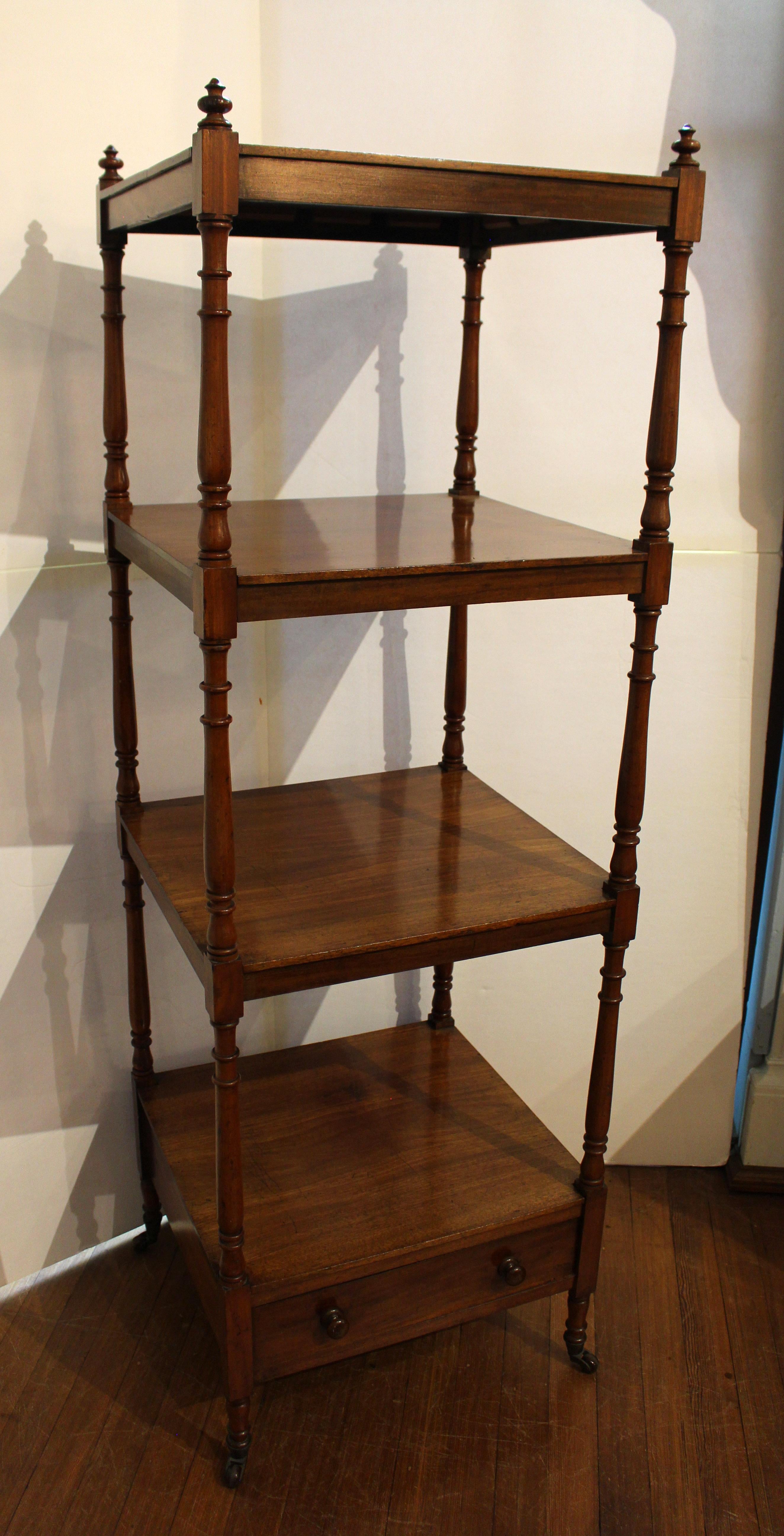 Regency period, early 19th century, tall what-not stand or etagere. English, mahogany. A rarely found tall example with 4 tiers over a drawer with original turned wood pulls. Nicely turned uprights with ring turnings & vasiform accents finished with
