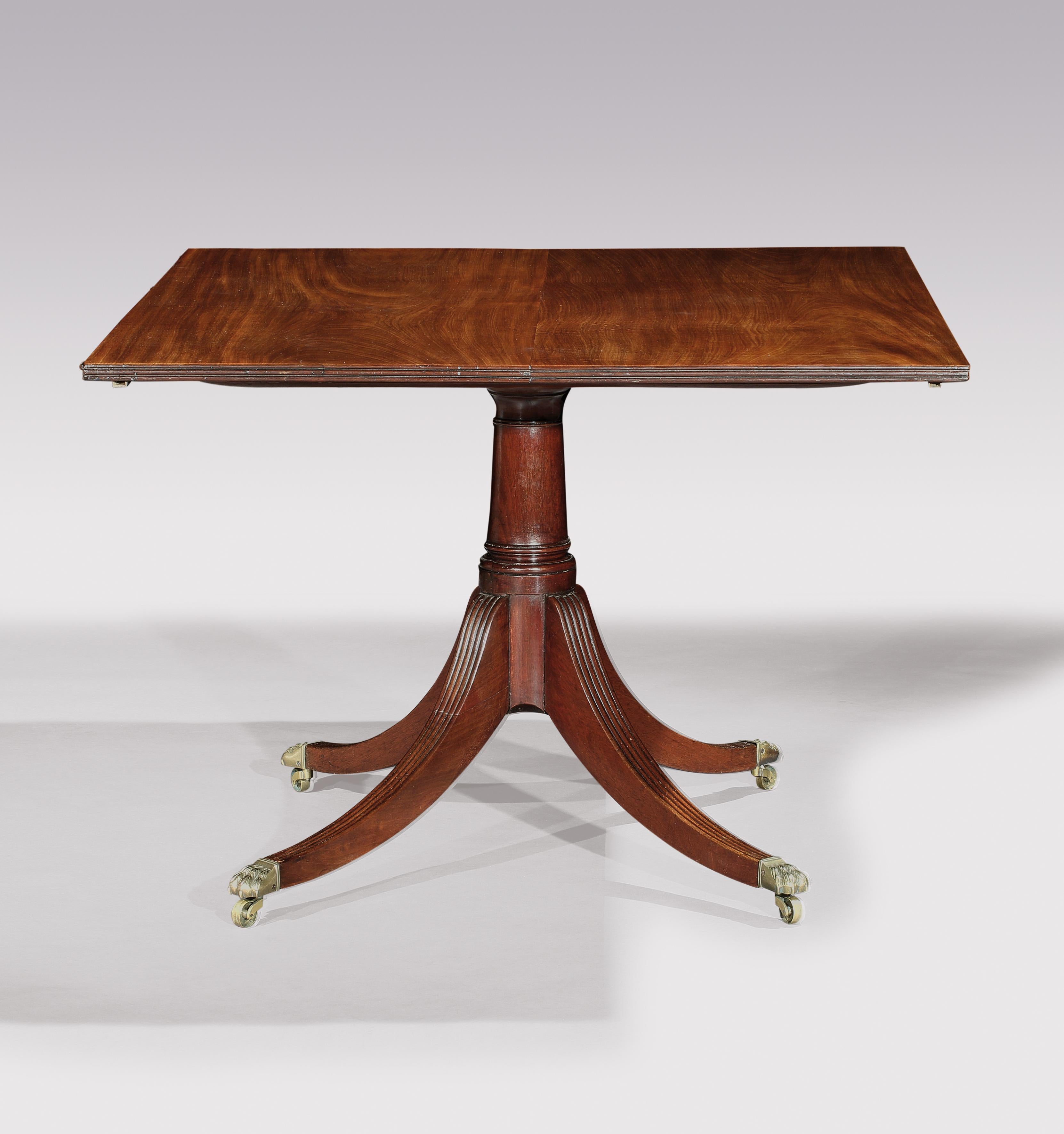 A fine early 19th century figured mahogany three pedestal dining table, having reeded edged top and half round ends, fitted with two contemporary leaves, supported on gun barrel stems, ending on 3 and 4 splay reeded legs with lions ' paw