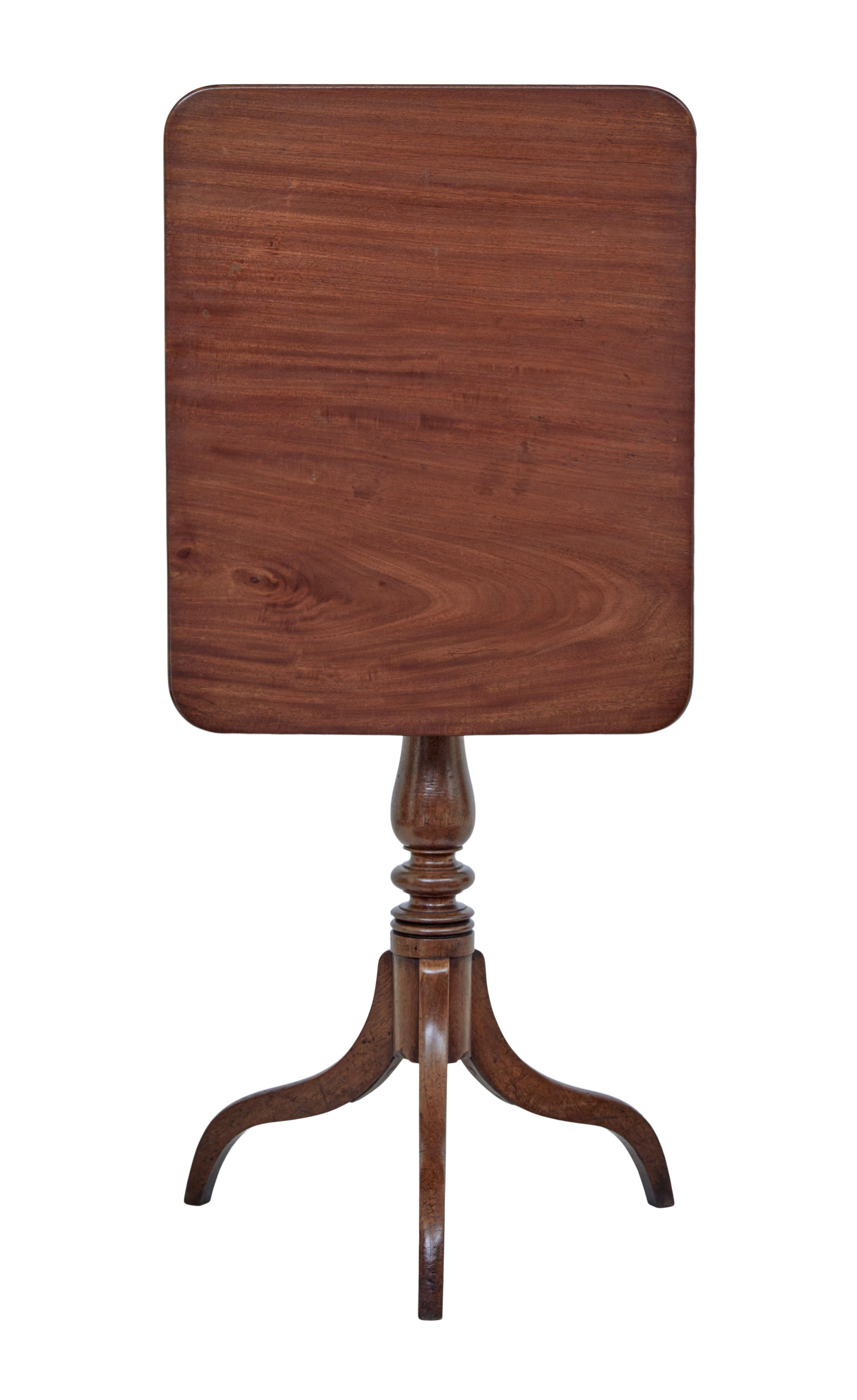 Early 19th century tilt-top occasional table, circa 1810.

Rectangular top with rounded corners. Standing on a turned stem and supported by 3 scrolling legs. Tilting mechanism allows easier storage.

Ideal for use as a lamp or side