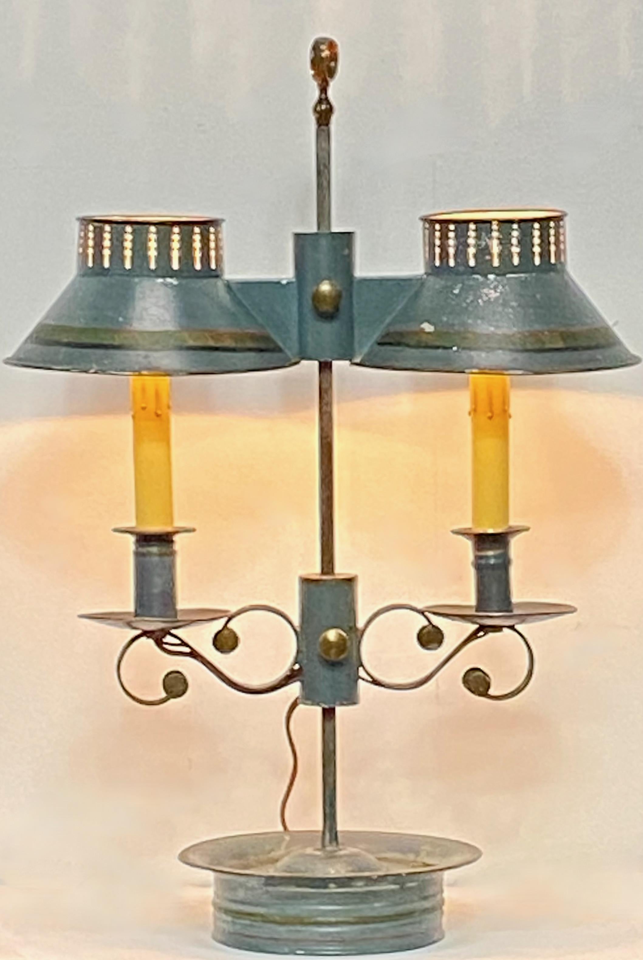 Original early 19th century green tole painted double student lamp in unusually good condition. 
Candle holder and shades are adjustable up and down.
Recently wired for electric.


  