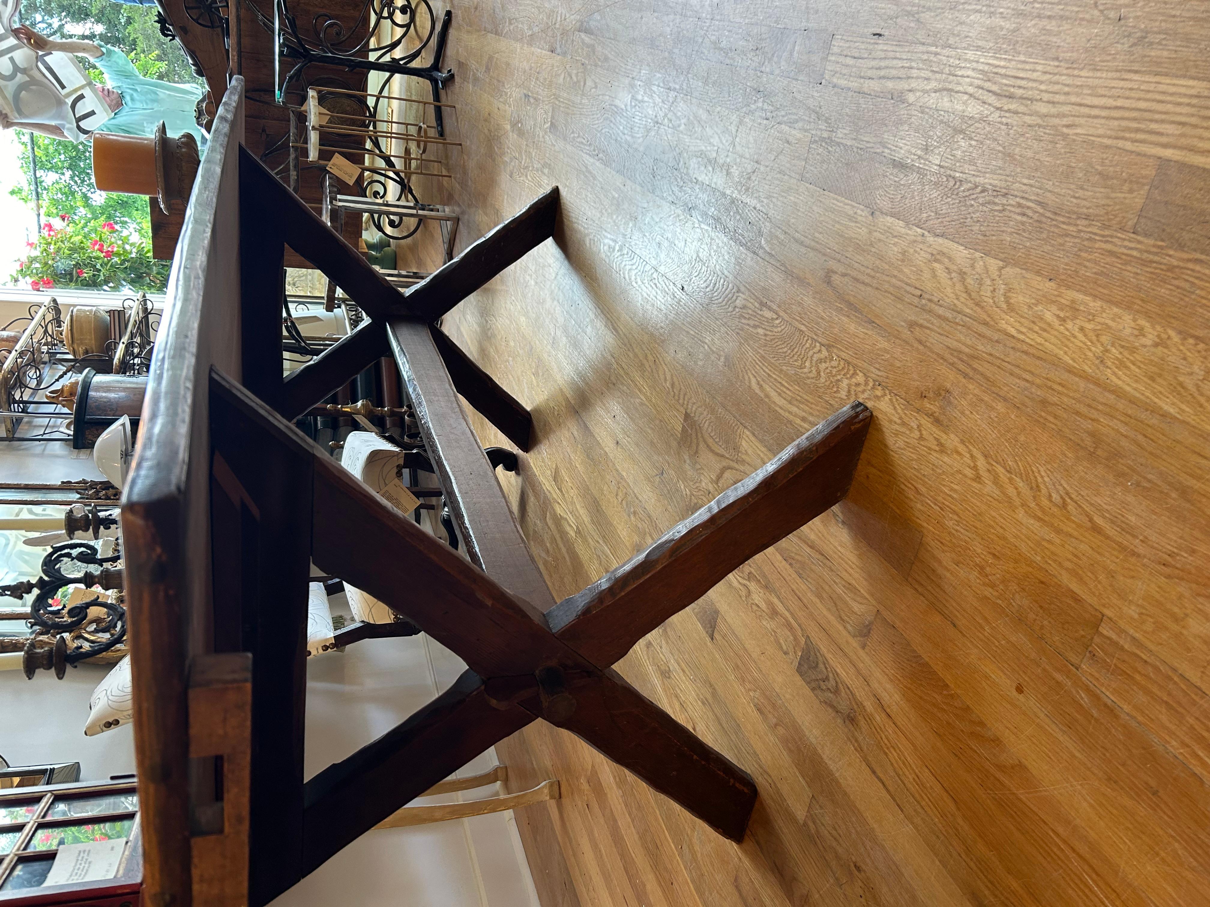 Early 19th century trestle or “Saw Buck” table. Made of Pine with a beautiful lustrous honey colored patination, good wide top over “X” formed base with central stretcher. Made in England circa 1820