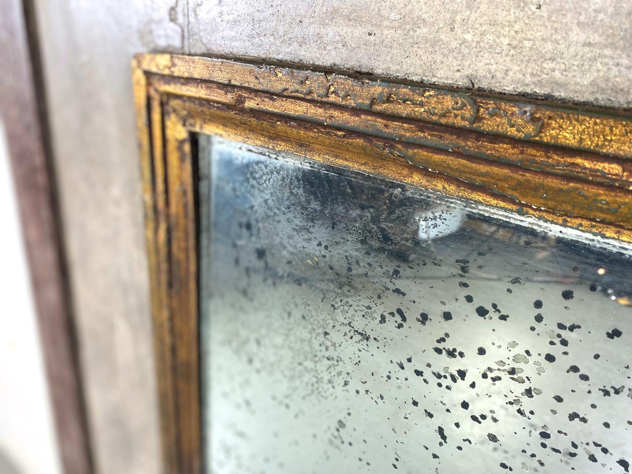 A 19th-century trumeau mirror. The mirror is of the period, the frame has a faux finish marble and a faux finish column on each side.  