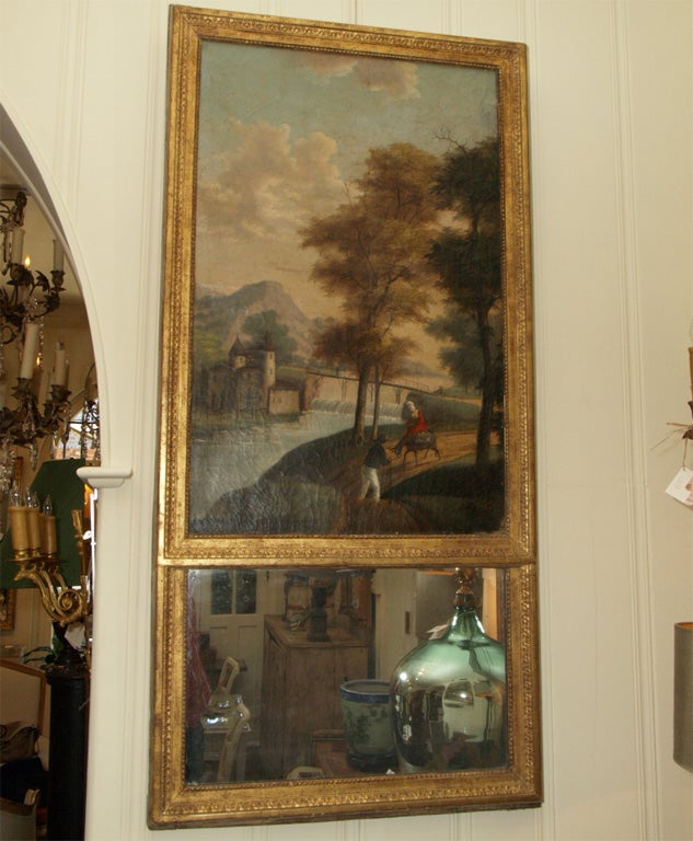 A finely painted naïve landscape with castle, a stone bridge over a small river with 2 figures in the foreground, a woman riding a donkey and a man walking on the road. Original mercury mirror, decorative frame with original gilt.