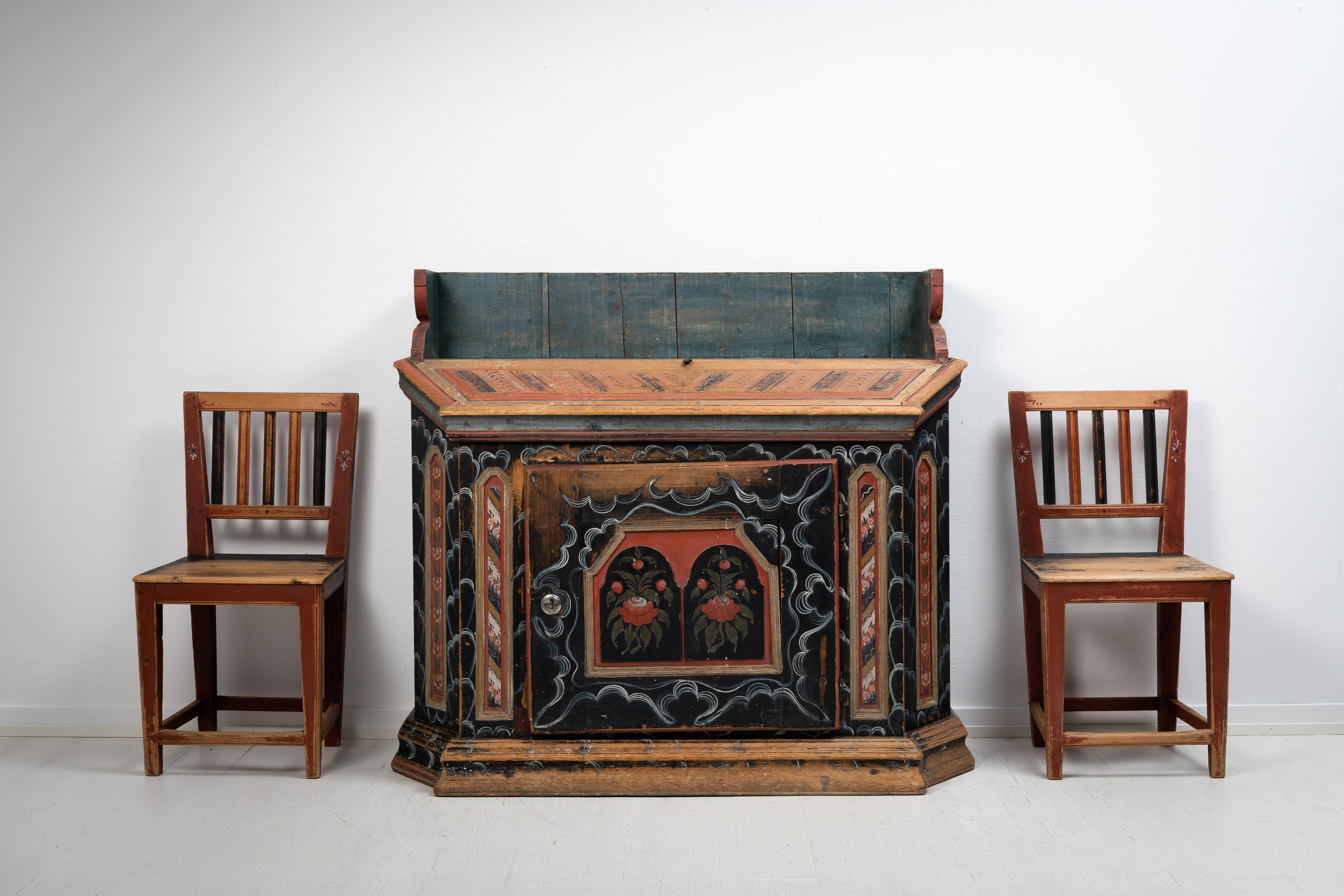 Swedish unusual folk art sideboard from Hälsingland in Sweden made during the early 1800s, around 1820 to 1830. The sideboard is painted pine with the original untouched paint. There is some distress and natural patina after use. The paint is a