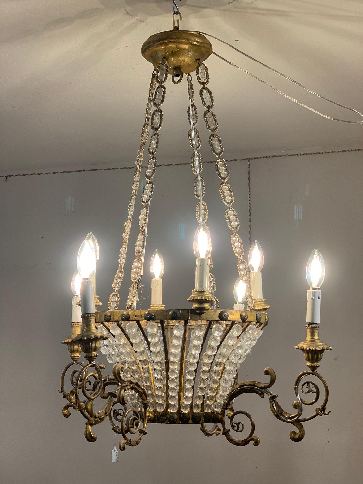 Beautiful basket chandelier, structure in gilded iron and spherical crystals, chains with crystal applications. Eight double move candle holder arms with flower bobeche.
It is possible to add a central light inside the basket and slightly lower the