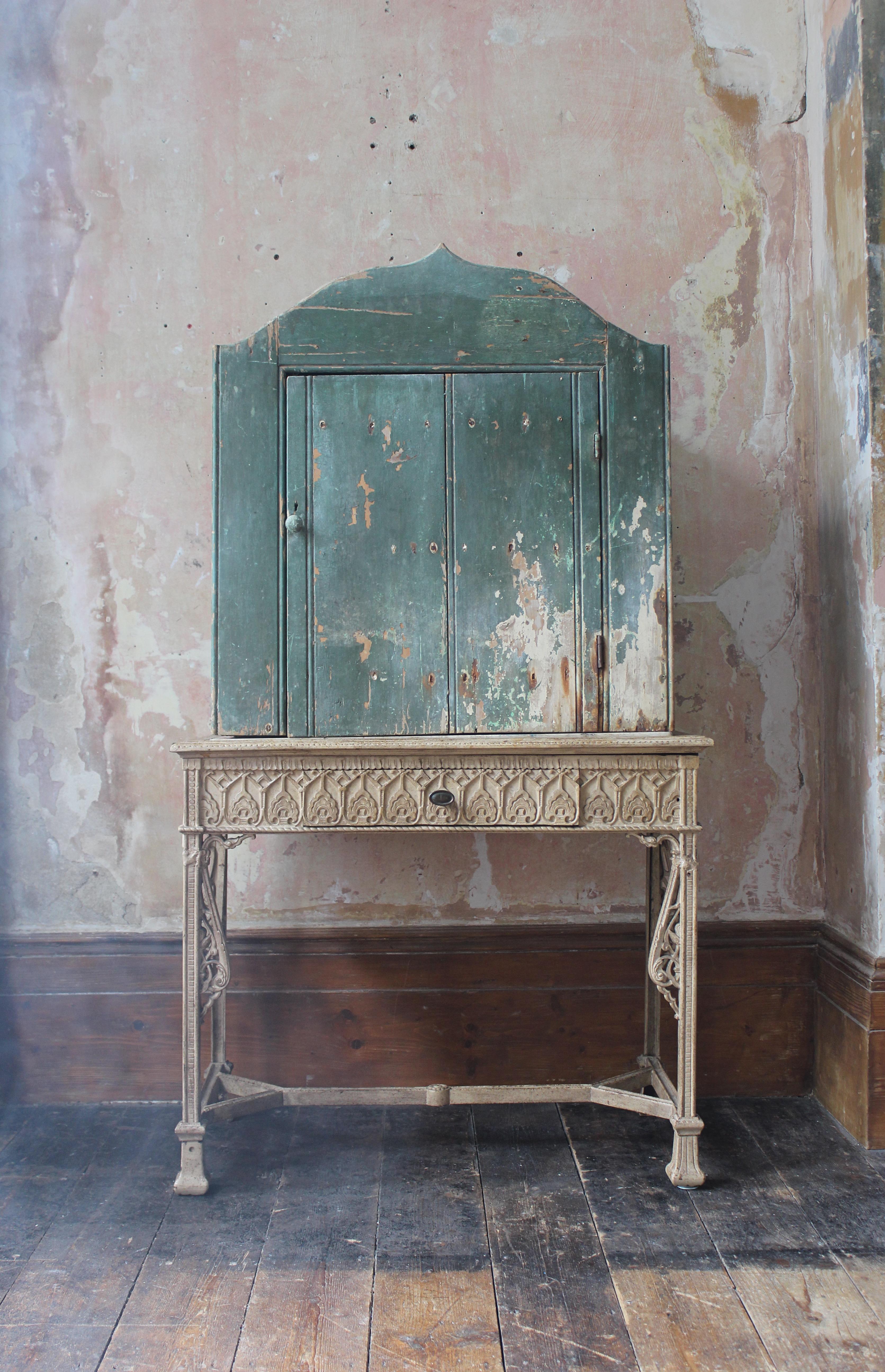 A vernacular cupboard, with the most marvellous original untouched green painted surface. 

Pine in construction, with intwined steel wire ties. The backing boards have black inked stamps for banana boxes.

Age related losses, craquelure to the