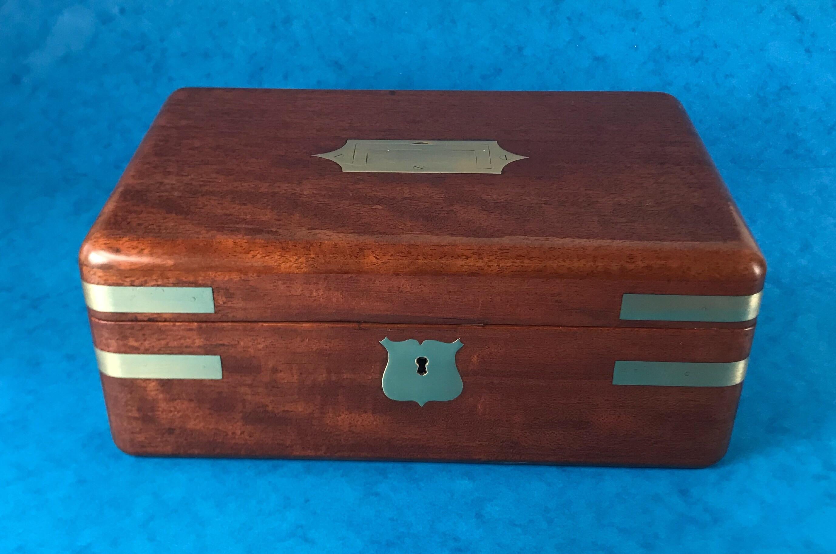A early 19th century, Victorian 1840 brass bound solid mahogany Campaign box with a relined interior, it has a military handle to the top, it has its original key but the key doesn’t work the lock. It measures 26 by 17 and stands 11 cm high.