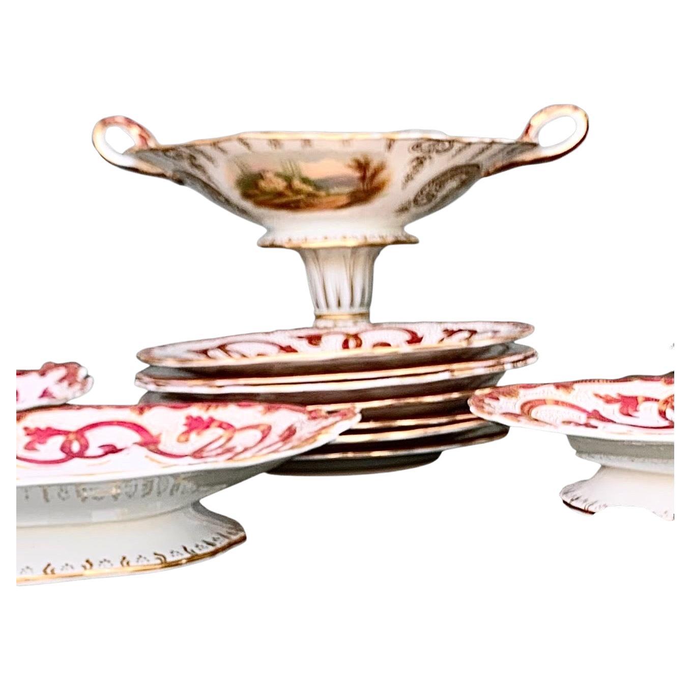 Outstanding and fine, thirteen piece English Staffordshire dessert set, 19th century, by W. Adams and Sons, Stoke-Upon-Trent, with exquisite hand-painted landscape reserves surrounded by broad magenta and gilt scroll borders, consisting of five