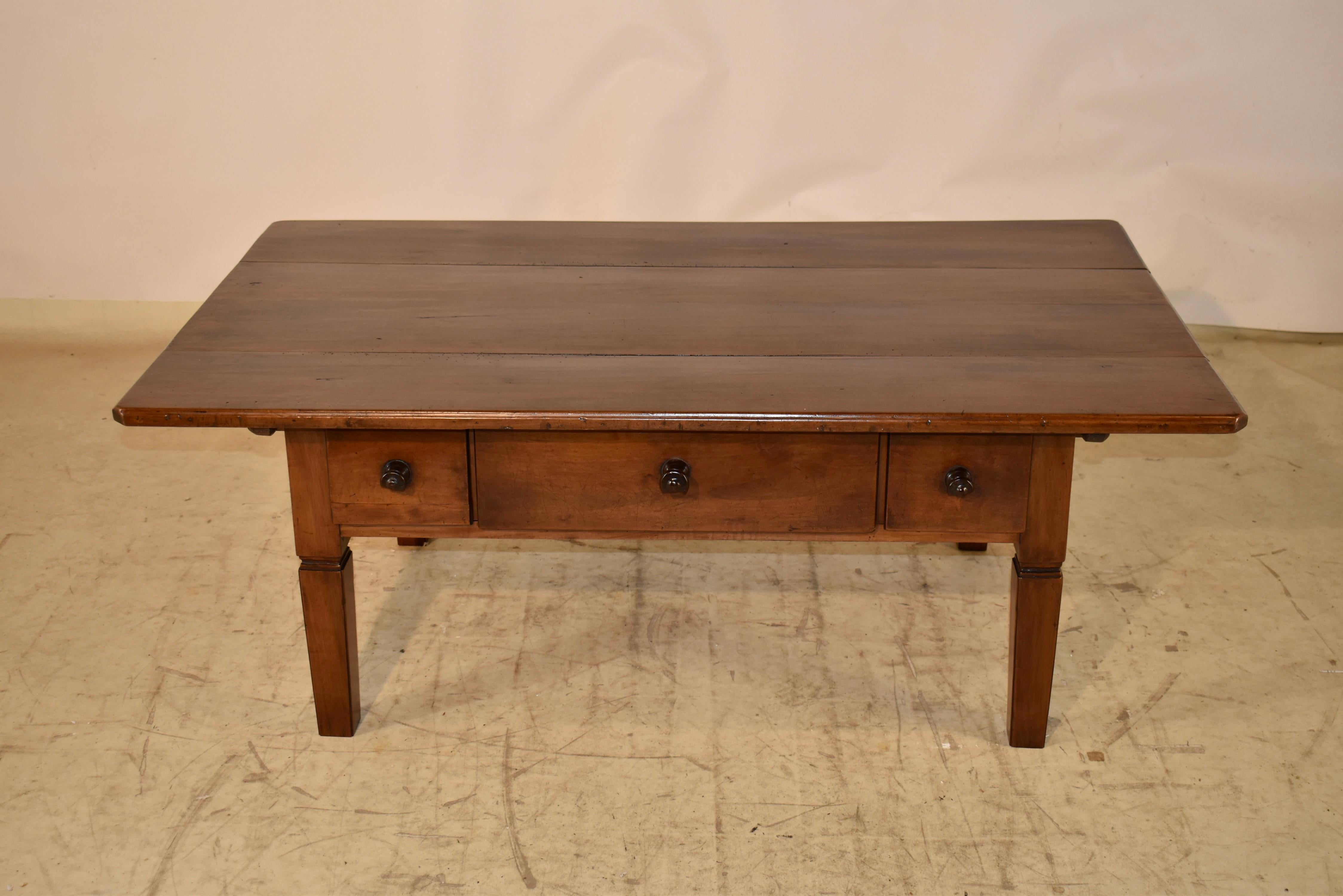 Early 19th century walnut coffee table from Switzerland.  This is a handsome table with great patina.  The top is made from three planks which have excellent color and graining throughout.  The top follows down to simple sides with hand carved