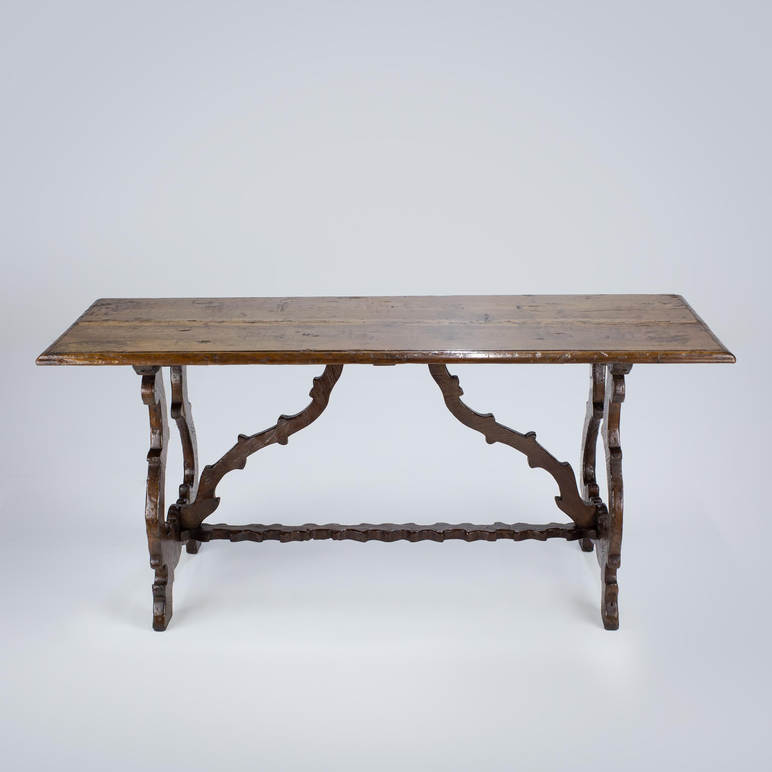 Early 19th Century Italian Trestle Table. Impressive patination and extraordinary stretchers. Wear and Patination as expected. Walnut. Italy, Circa 1860.
