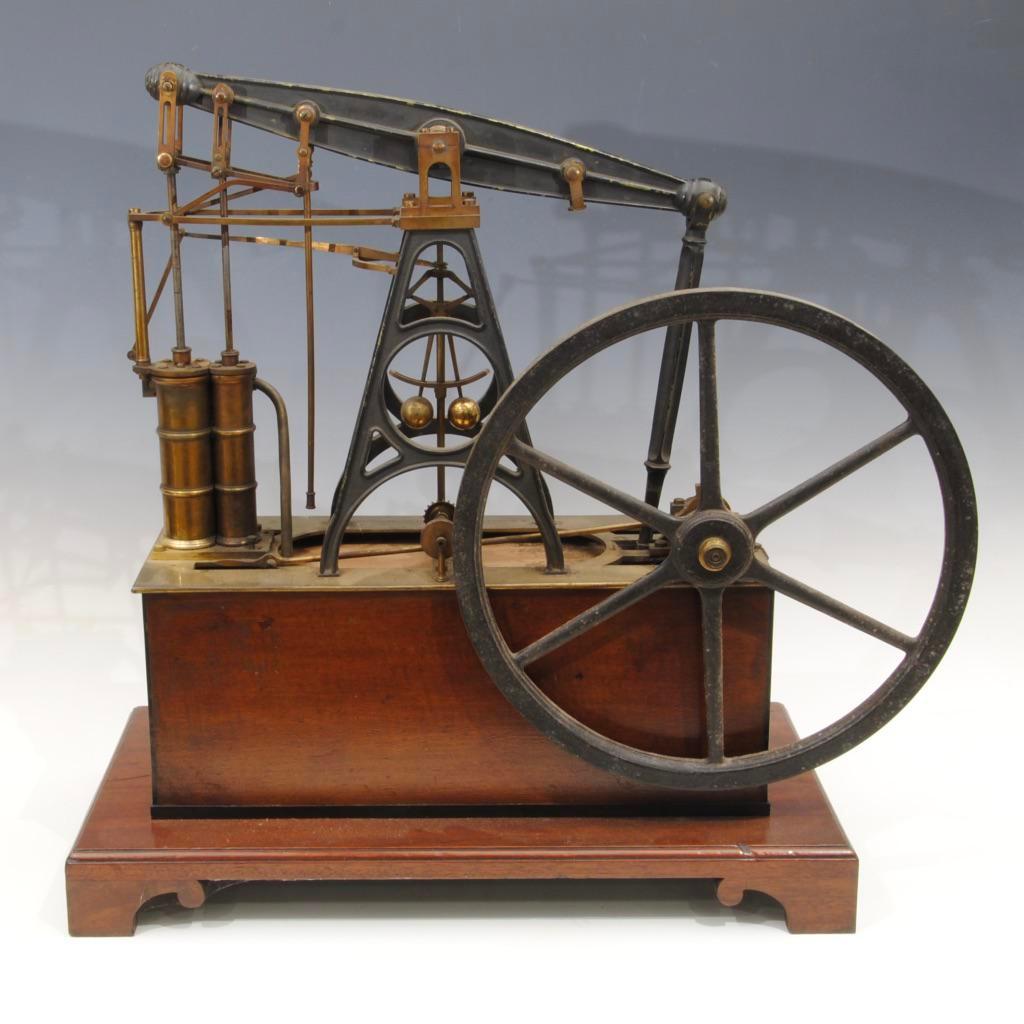 A rare early 19th century demonstration model of a steam driven beam engine made by Watkins and Hill, London standing on a mahogany and ebony stung base
 
A similar example can be found in the Oxford science museum.