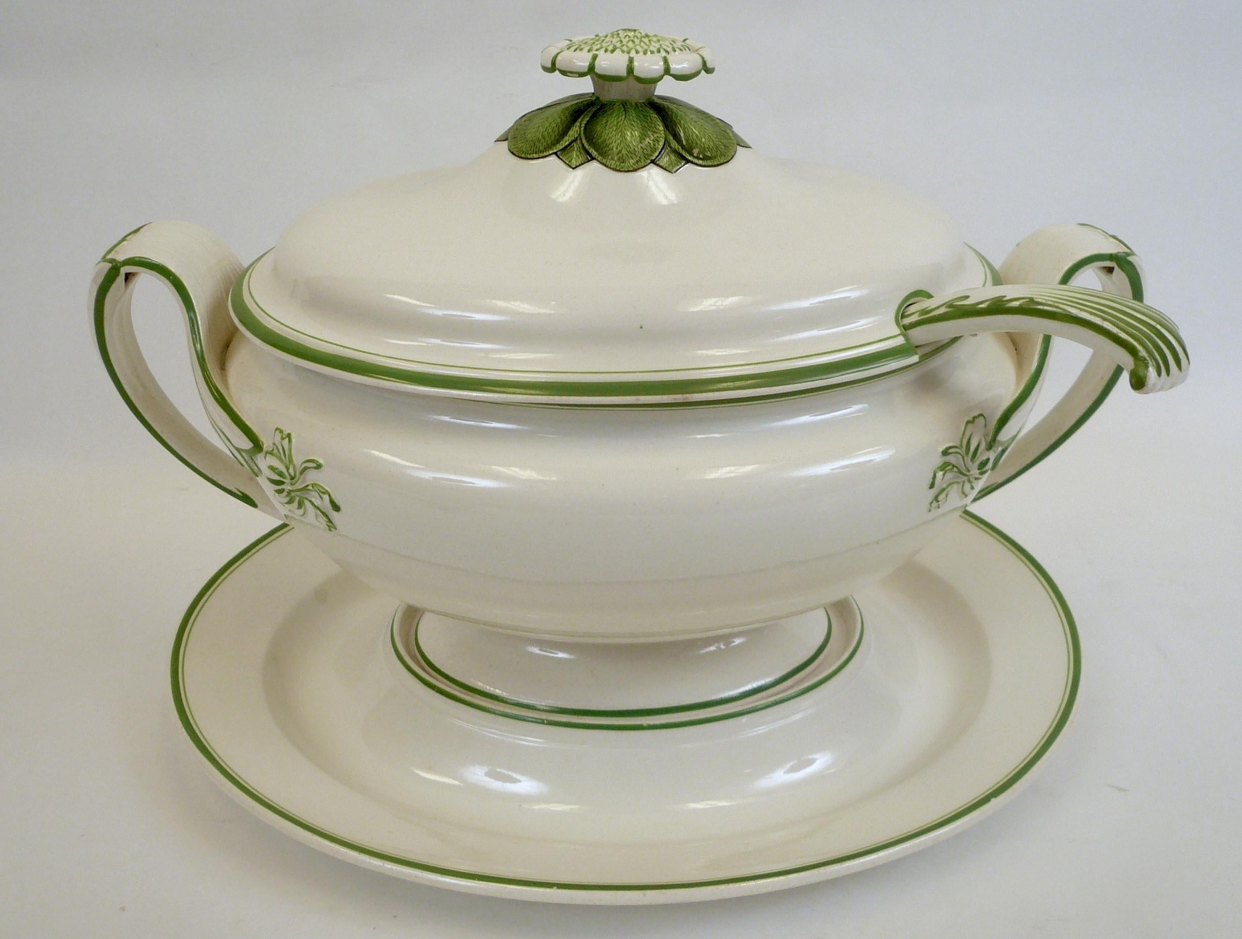 Creamware is a cream colored refined earthenware first produced in the mid-18th century, and perfected by Wedgwood in the 1760s. This tureen is in the Classic Wedgwood shape, and features acanthus leaves, and an artichoke finial. It consists of four