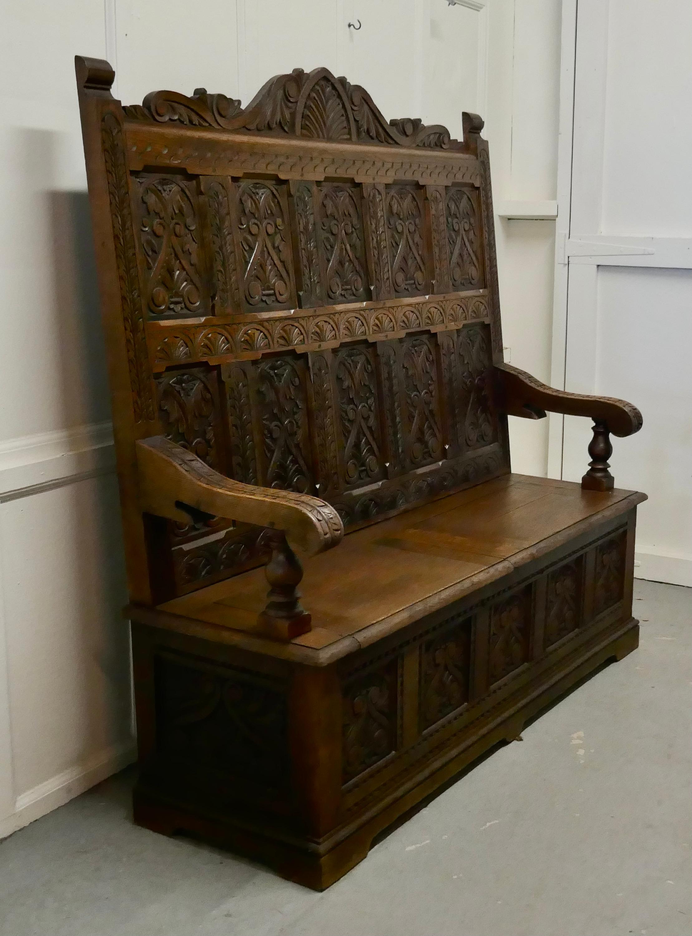 Early 19th century welsh high back carved oak box settle

The settle has a superbly carved high back panel with 10 panels carved with a Celtic pattern, and 5 further carved panels at the bottom, the seat opens in 2 sections for storage
The bench