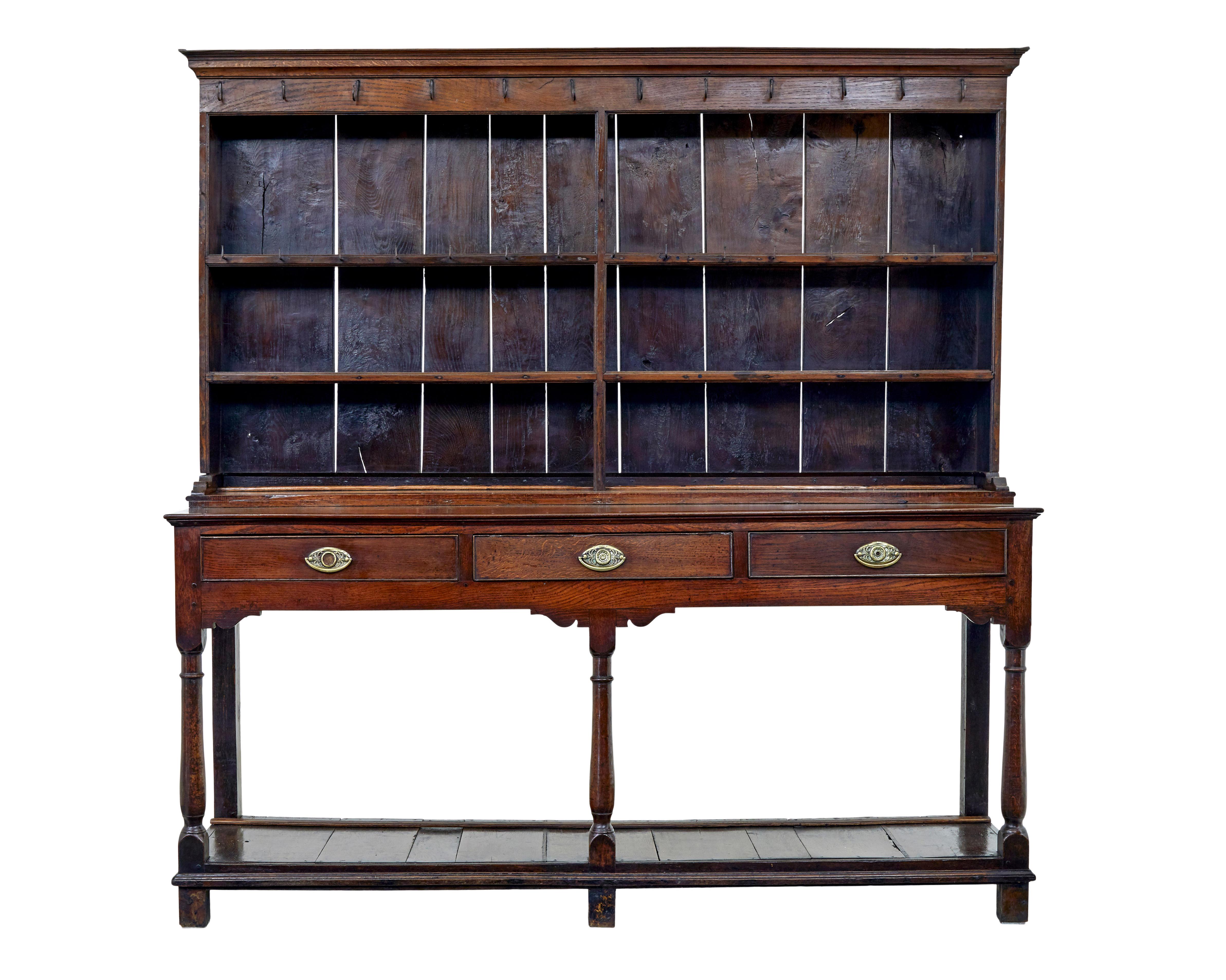 Superb quality 18th century welsh dresser and rack from the Montgomeryshire region circa 1815.

Comprising of 2 parts.  Top section with 2 shelves and central partition and some of the original hooks in place, others with later replacements.  1